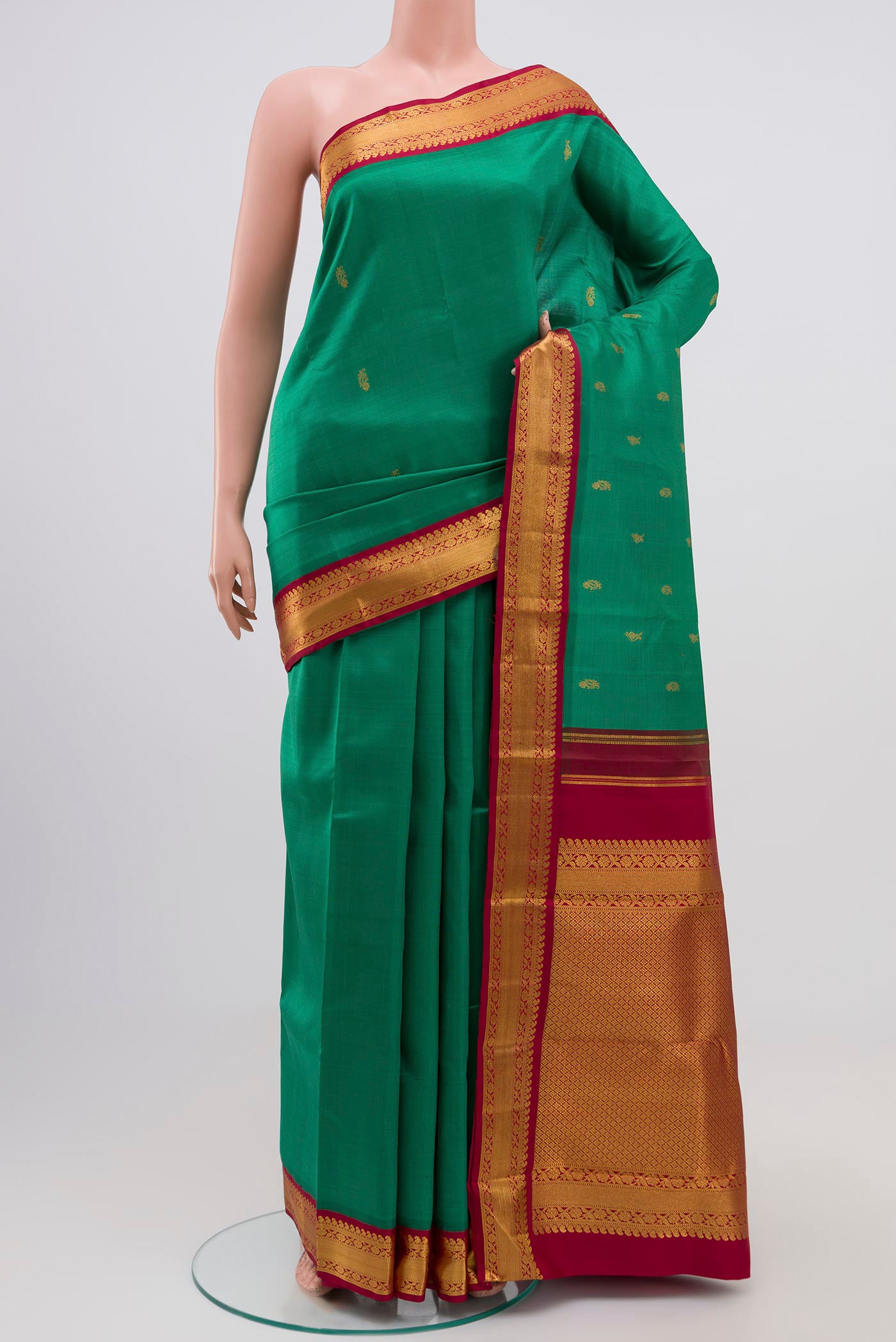 Pure Silk Pure Zari Green Kanchipuram Saree with Zari Butta on the body and Zari Border.  displayed on a mannequin