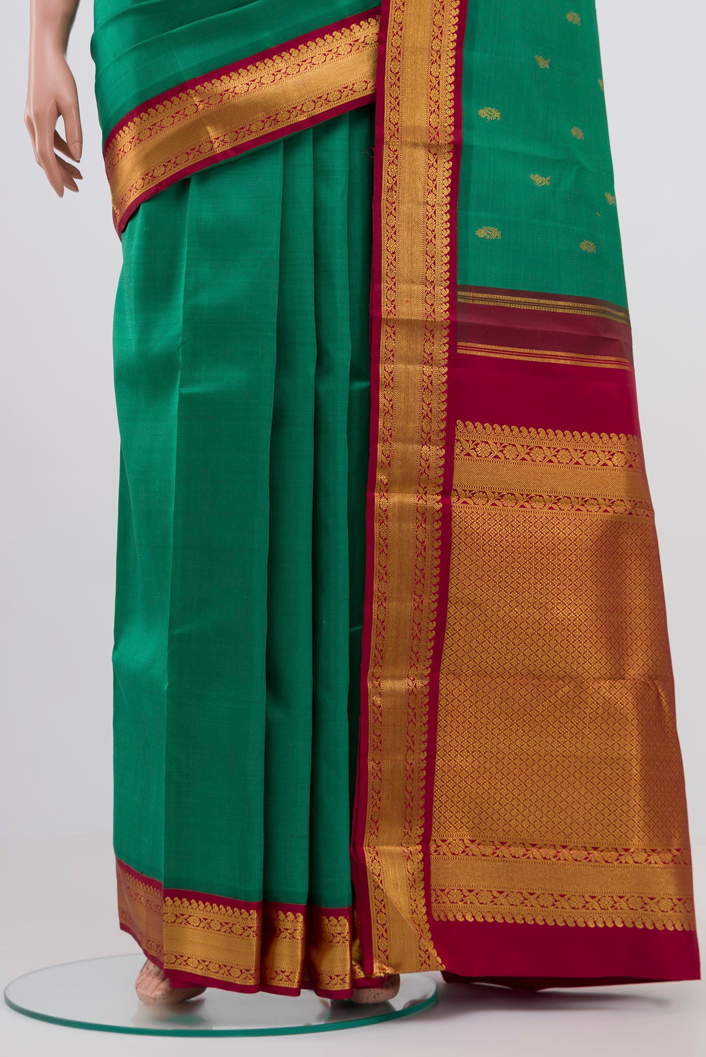 Pleats and pallu of Pure Silk Pure Zari Green Kanchipuram Saree with Zari Butta on the body and Zari Border. 