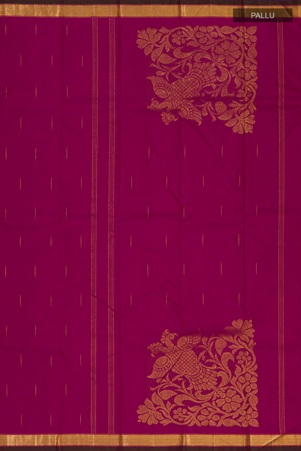 Close up image of the pallu of Magenta Kanjivaram Silk Saree with Zari Butta on the body and Zari Border. 