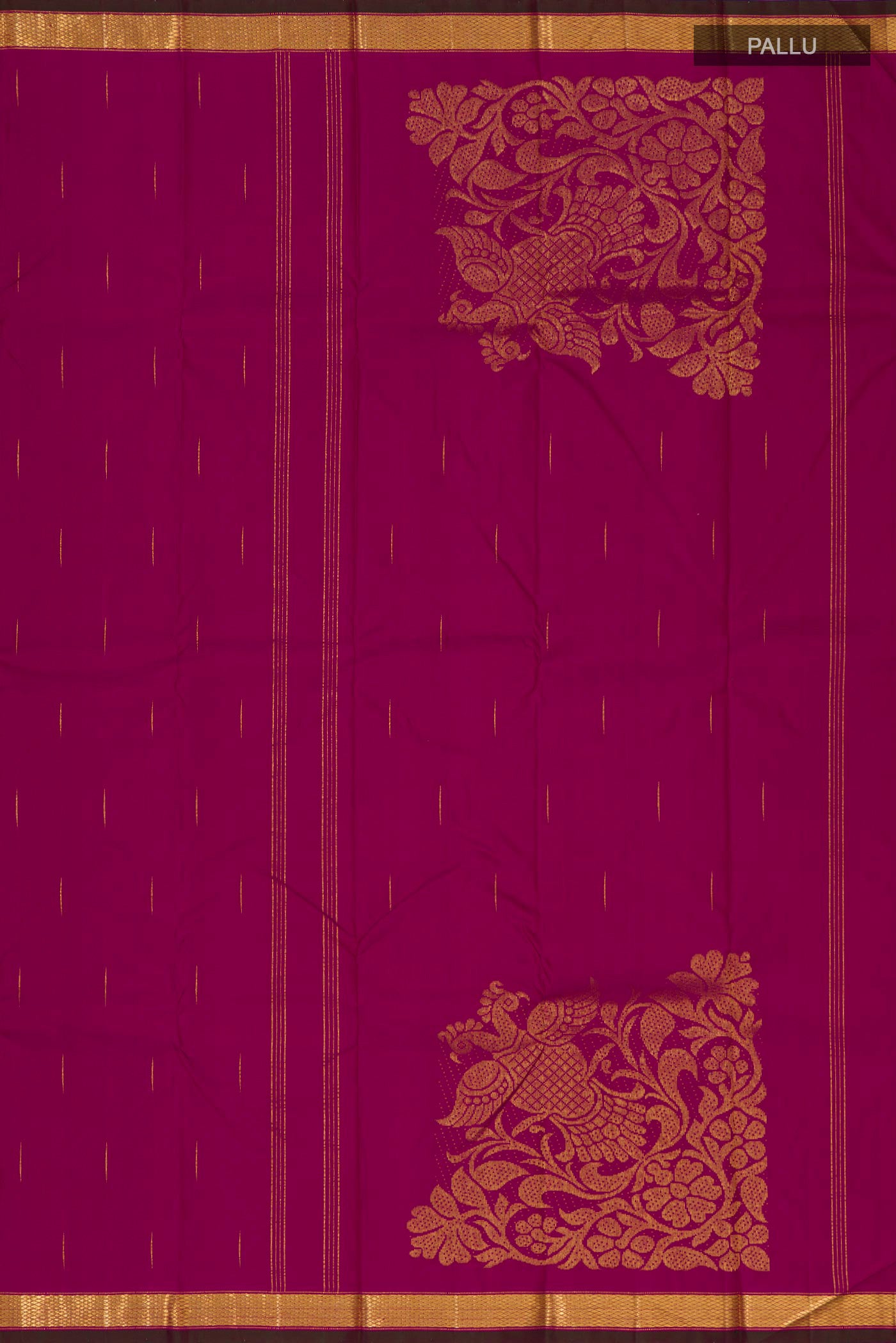 Close up image of the pallu of Magenta Kanjivaram Silk Saree with Zari Butta on the body and Zari Border. 