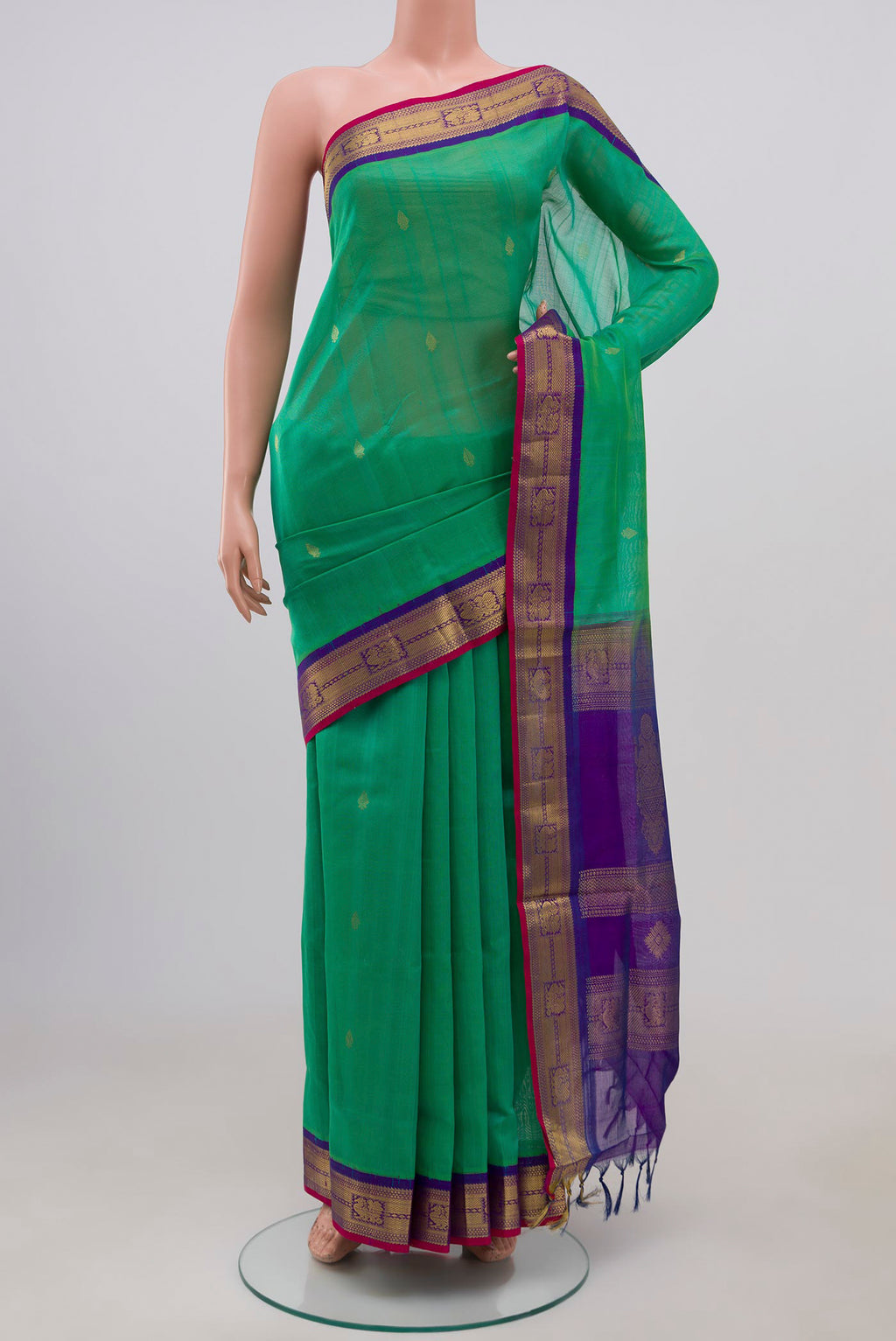 Green Coimbatore Silk Cotton Saree with Zari Butta on the body and Zari Border.  displayed on a mannequin