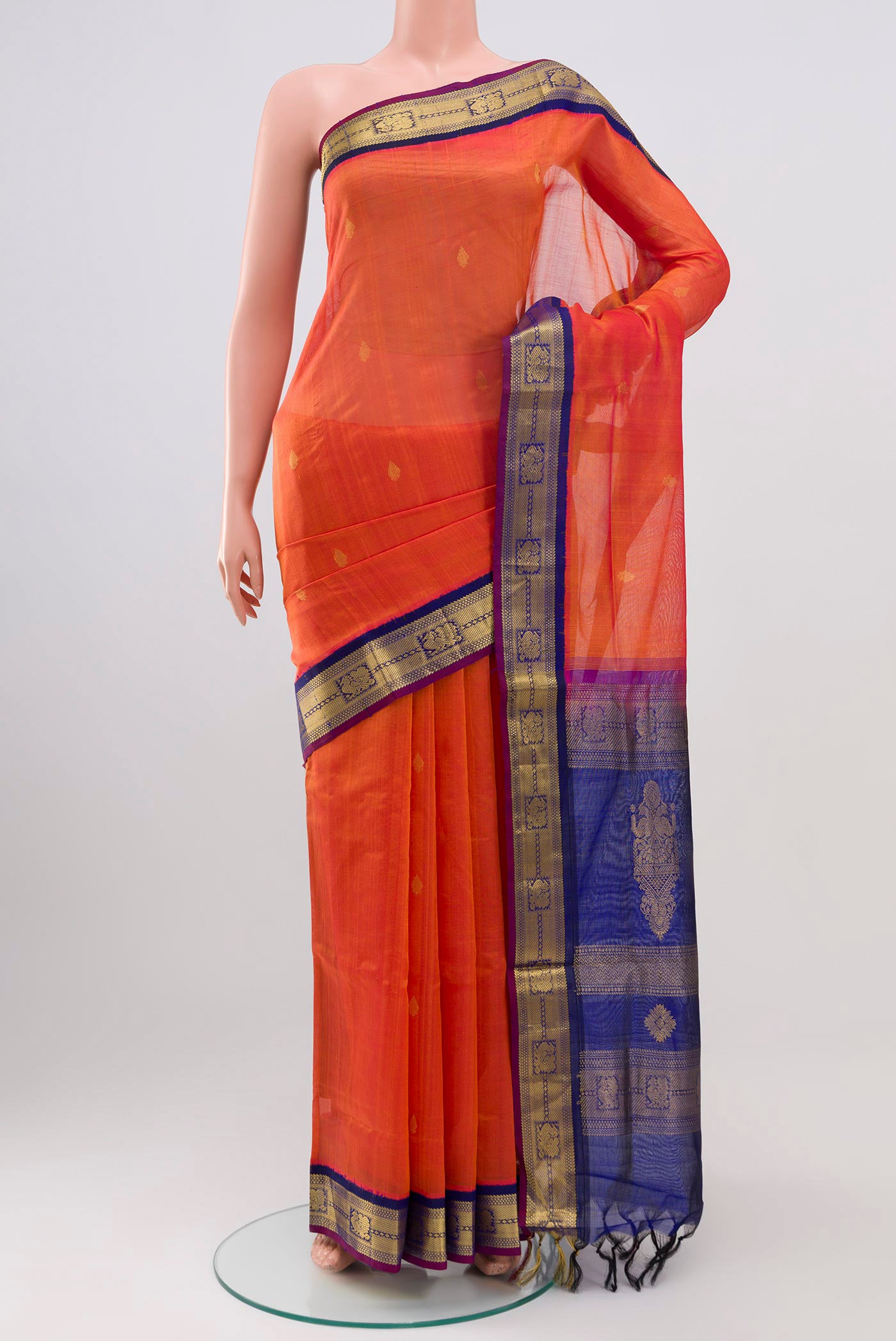 Orange Silk Cotton Saree with Zari Butta on the body and Zari Border.  displayed on a mannequin