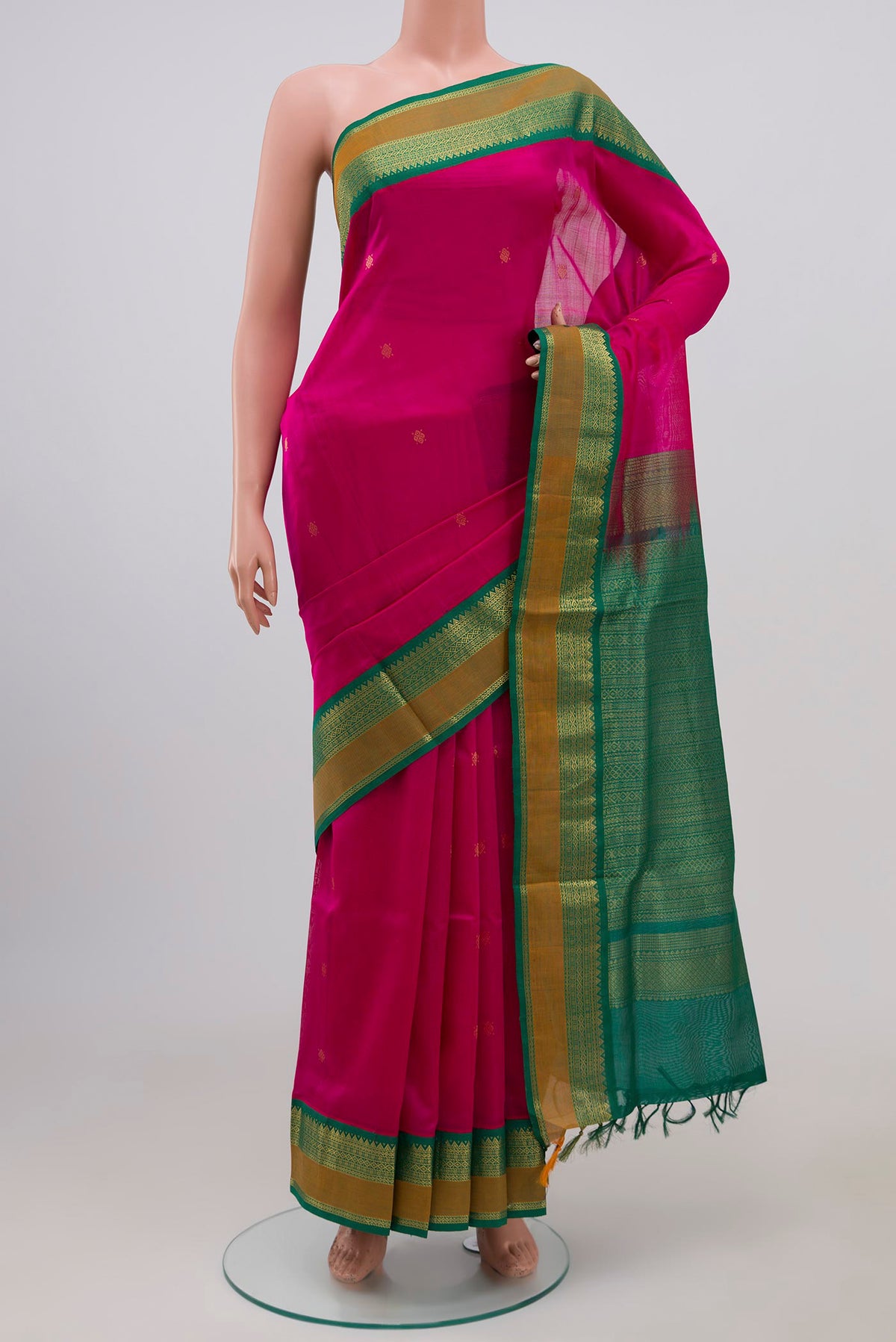 Rani Pink Coimbatore Silk Cotton Saree with Zari Butta on the body and Zari Border.  displayed on a mannequin
