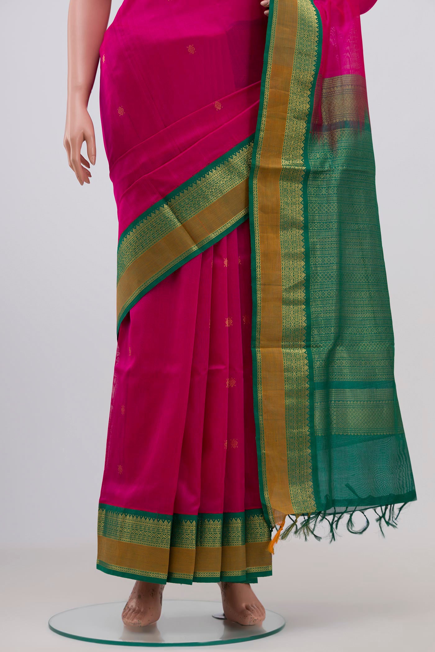 Pleats and pallu of Rani Pink Coimbatore Silk Cotton Saree with Zari Butta on the body and Zari Border. 