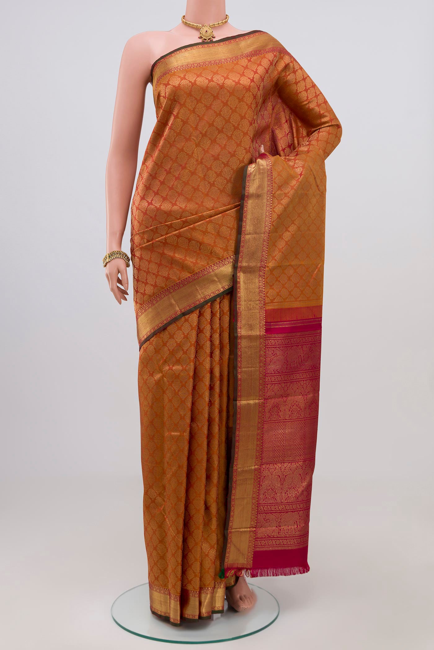 Pure Silk Pure Zari Orange Kanjivaram Saree with Zari Brocade on the body and Zari Border.  displayed on a mannequin