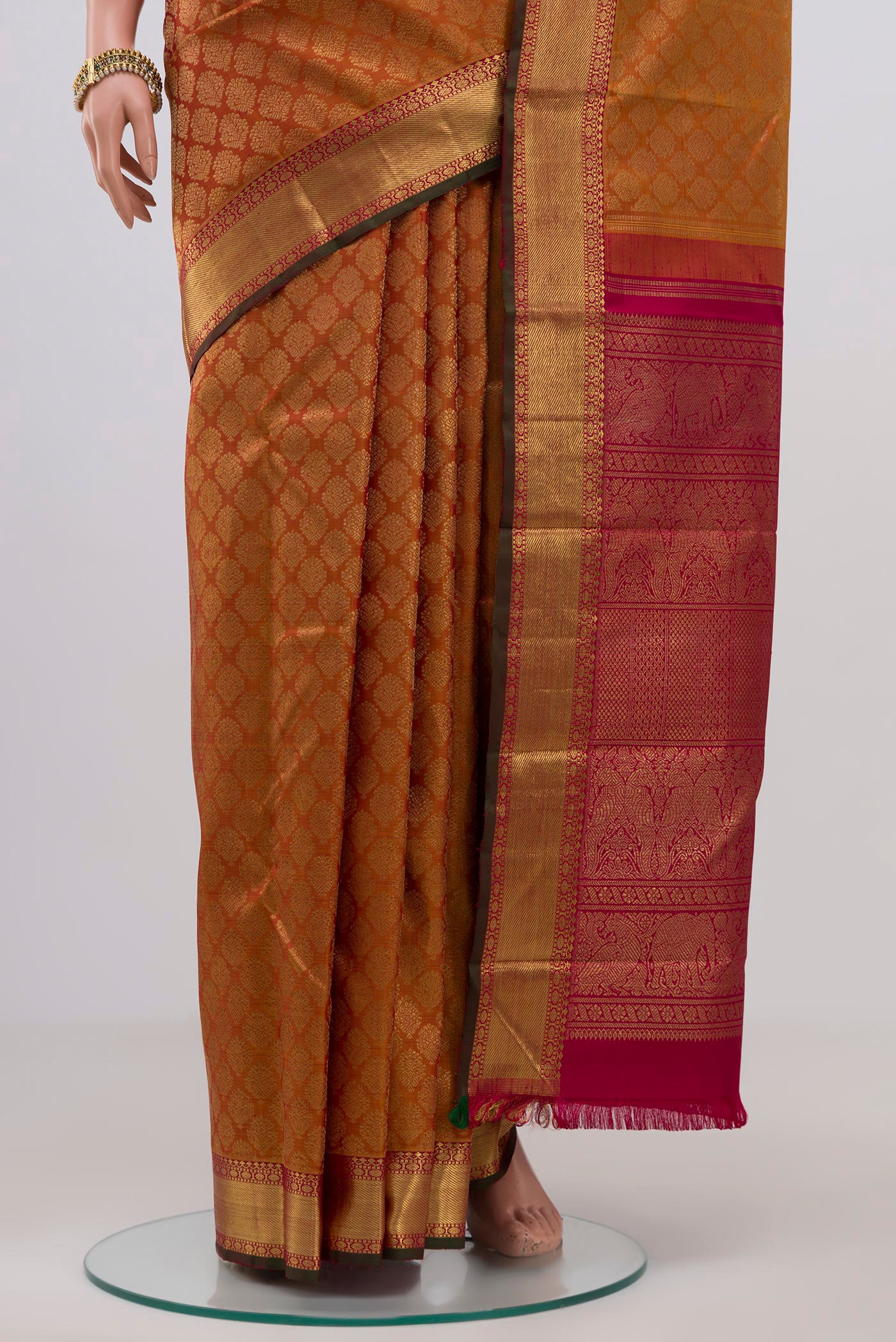 Pleats and pallu of Pure Silk Pure Zari Orange Kanjivaram Saree with Zari Brocade on the body and Zari Border. 