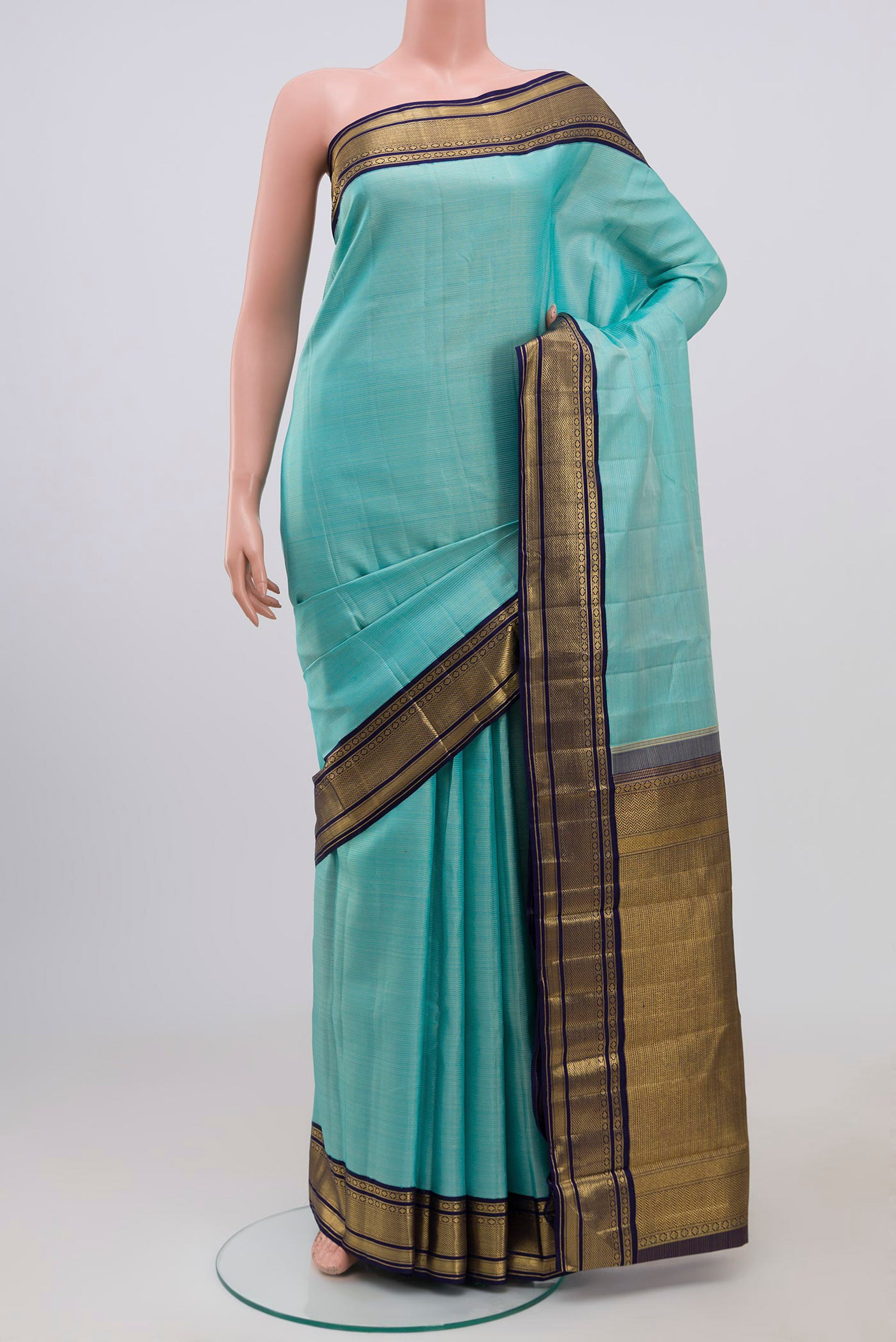 Pure Silk Pure Zari Sky Blue Kanchipuram Saree with Stripes on the body and Zari Border.  displayed on a mannequin
