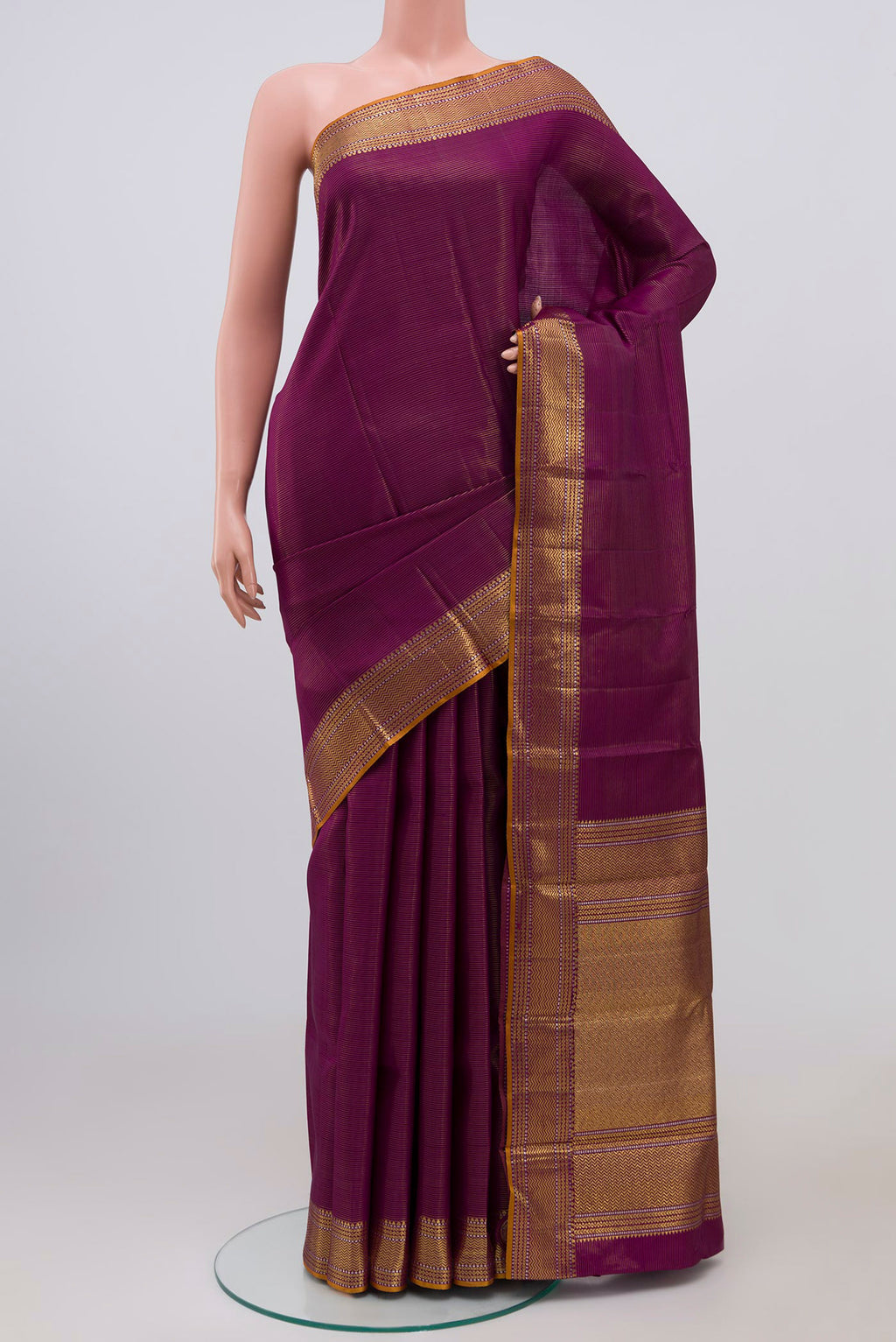 Magenta Kanjivaram Silk Saree with Stripes on the body and Zari Border.  displayed on a mannequin