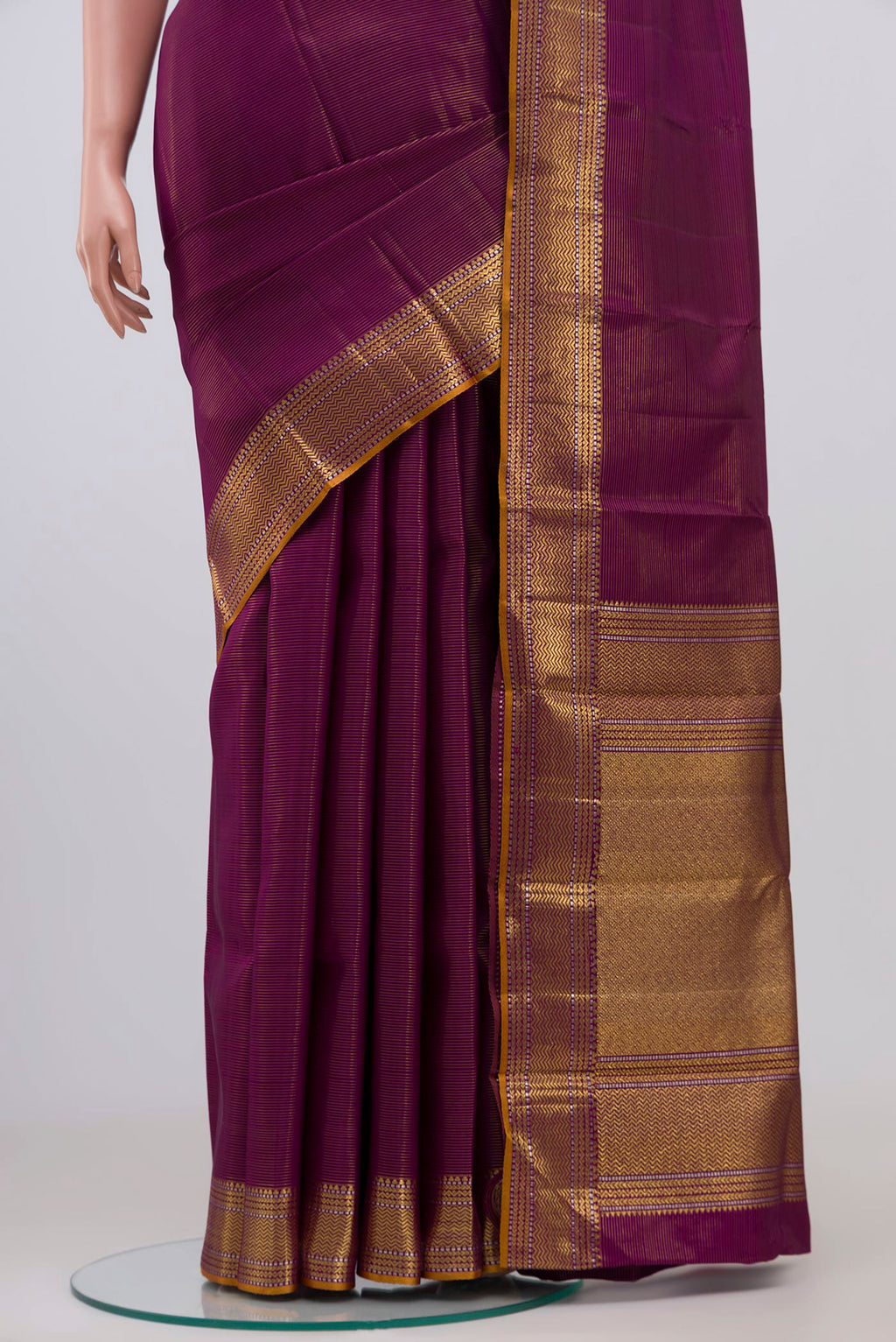 Pleats and pallu of Magenta Kanjivaram Silk Saree with Stripes on the body and Zari Border. 