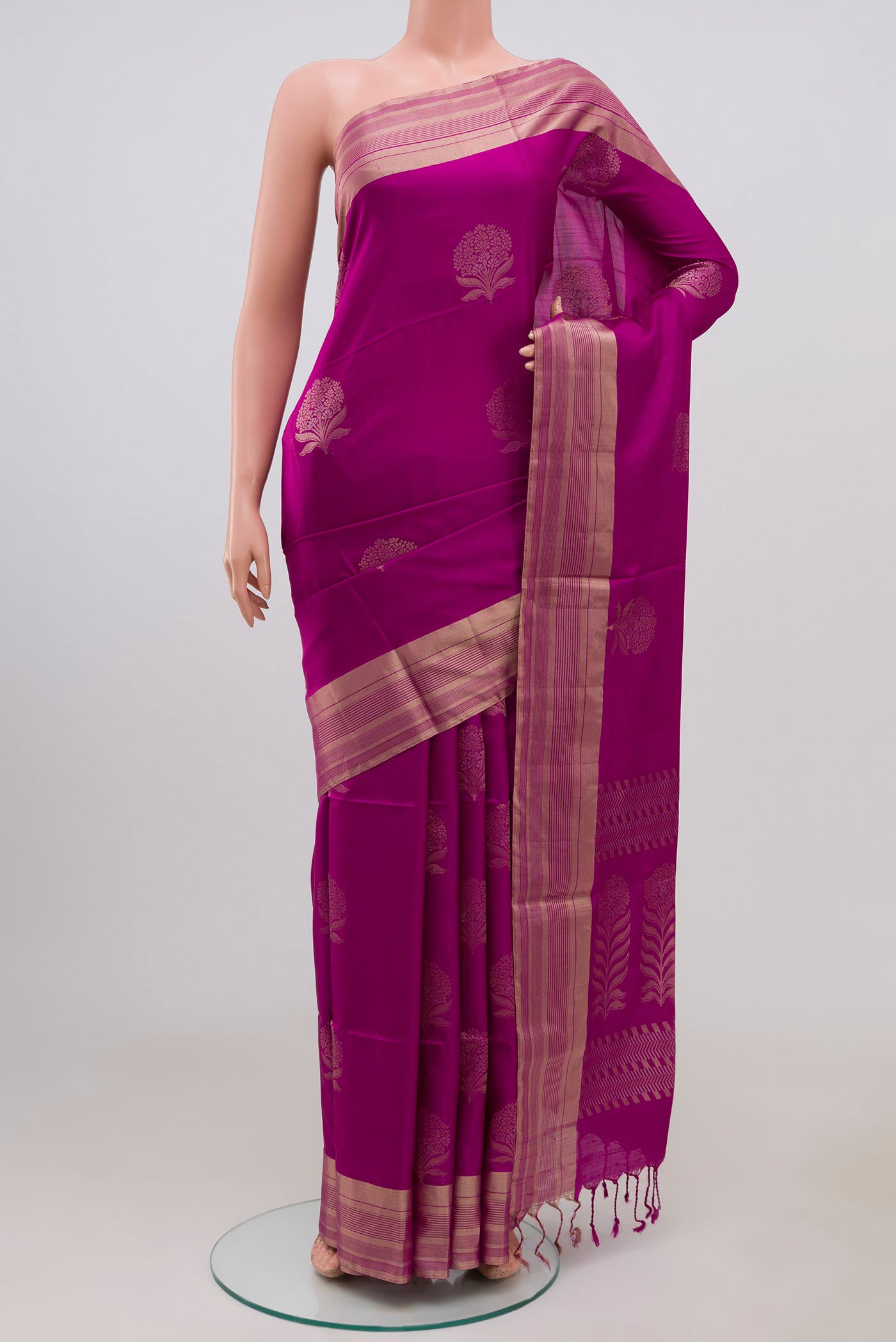 Magenta Soft Silk Saree with Zari Butta on the body and Zari Border.  displayed on a mannequin