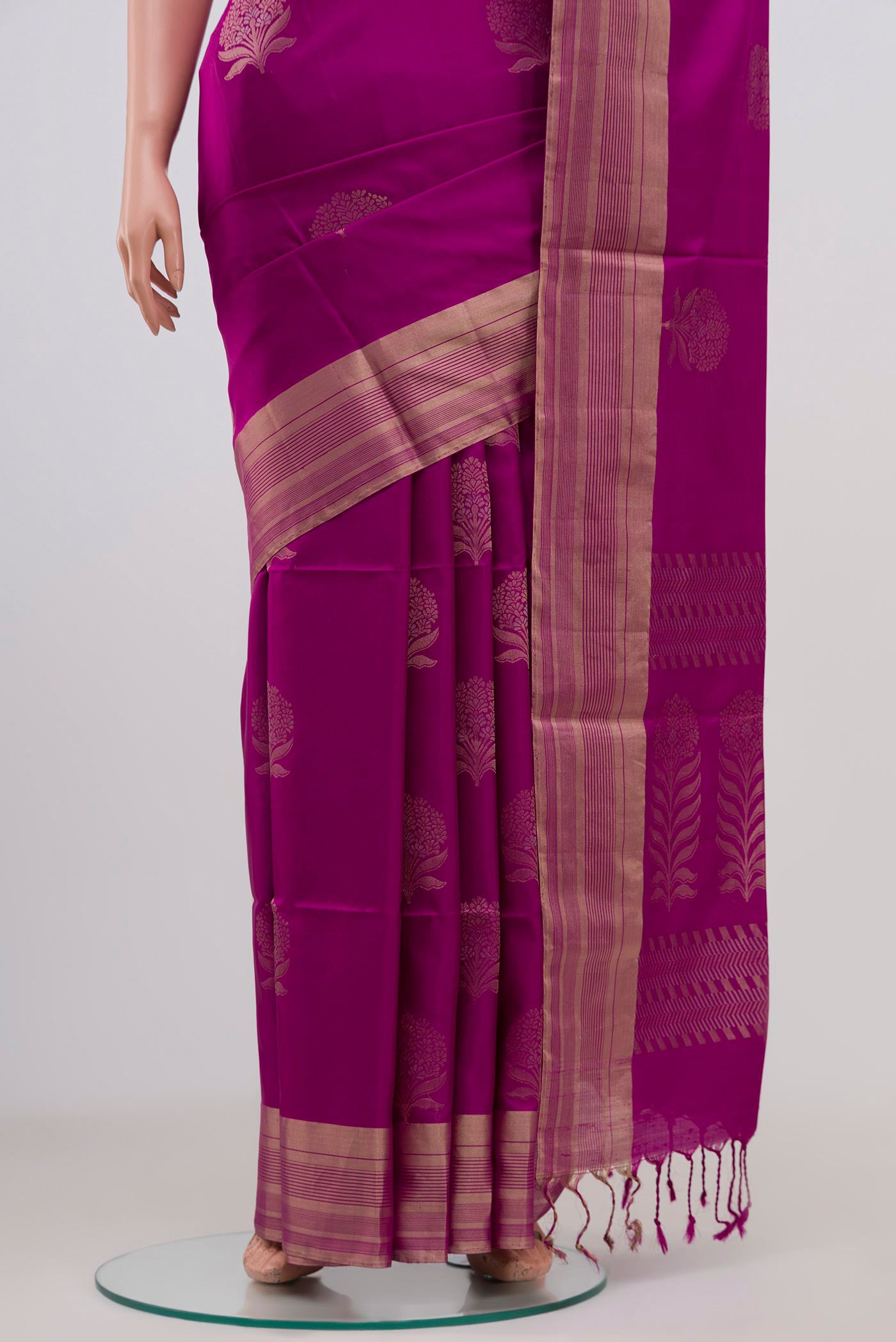 Pleats and pallu of Magenta Soft Silk Saree with Zari Butta on the body and Zari Border. 