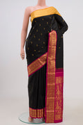 Pure Silk Pure Zari Black Kanjivaram Saree with Zari Butta on the body and Zari Border.  displayed on a mannequin