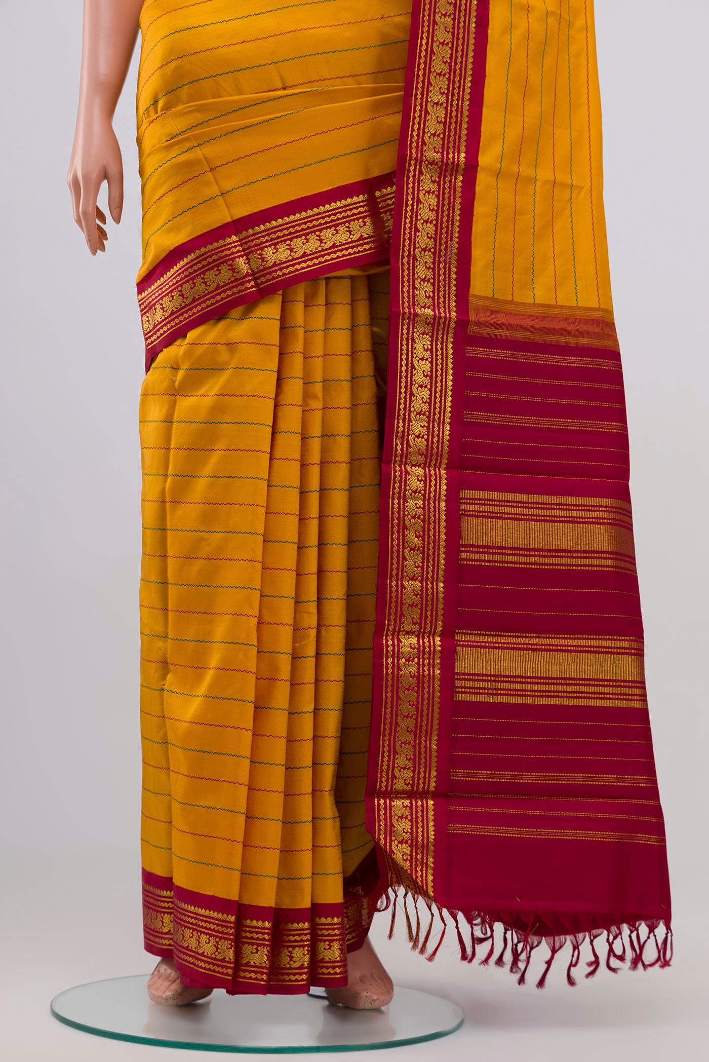 Pleats and pallu of Pure Silk Pure Zari Mustard Kanjivaram Saree with Veldhari on the body and Zari Border. 