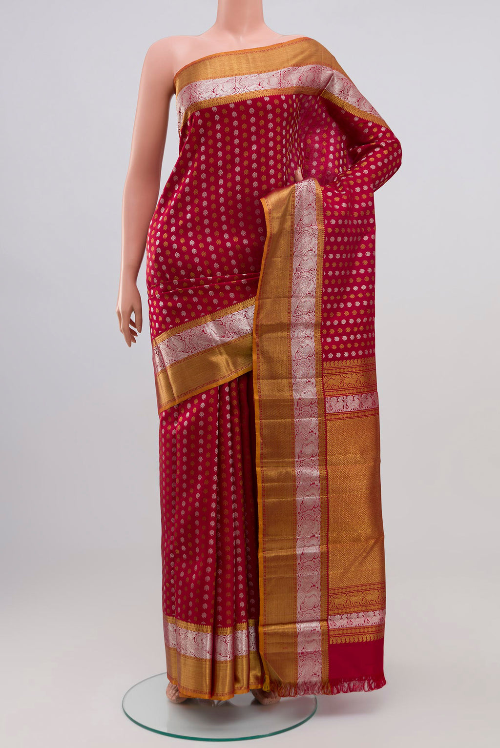 Maroon Kanchipuram Silk Saree with Zari Butta on the body and Zari Border.  displayed on a mannequin