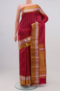 Maroon Kanchipuram Silk Saree with Zari Butta on the body and Zari Border.  displayed on a mannequin