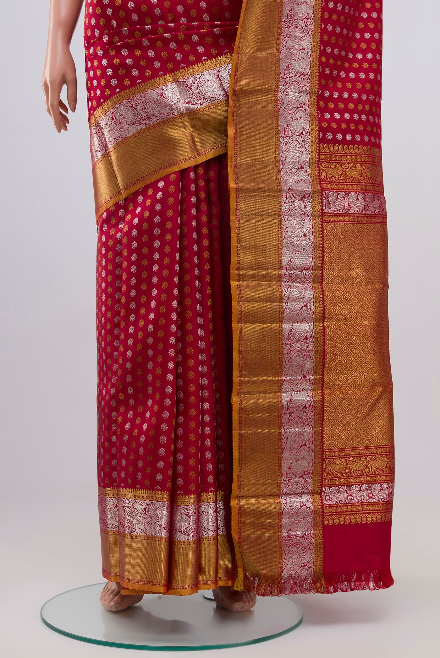 Pleats and pallu of Maroon Kanchipuram Silk Saree with Zari Butta on the body and Zari Border. 