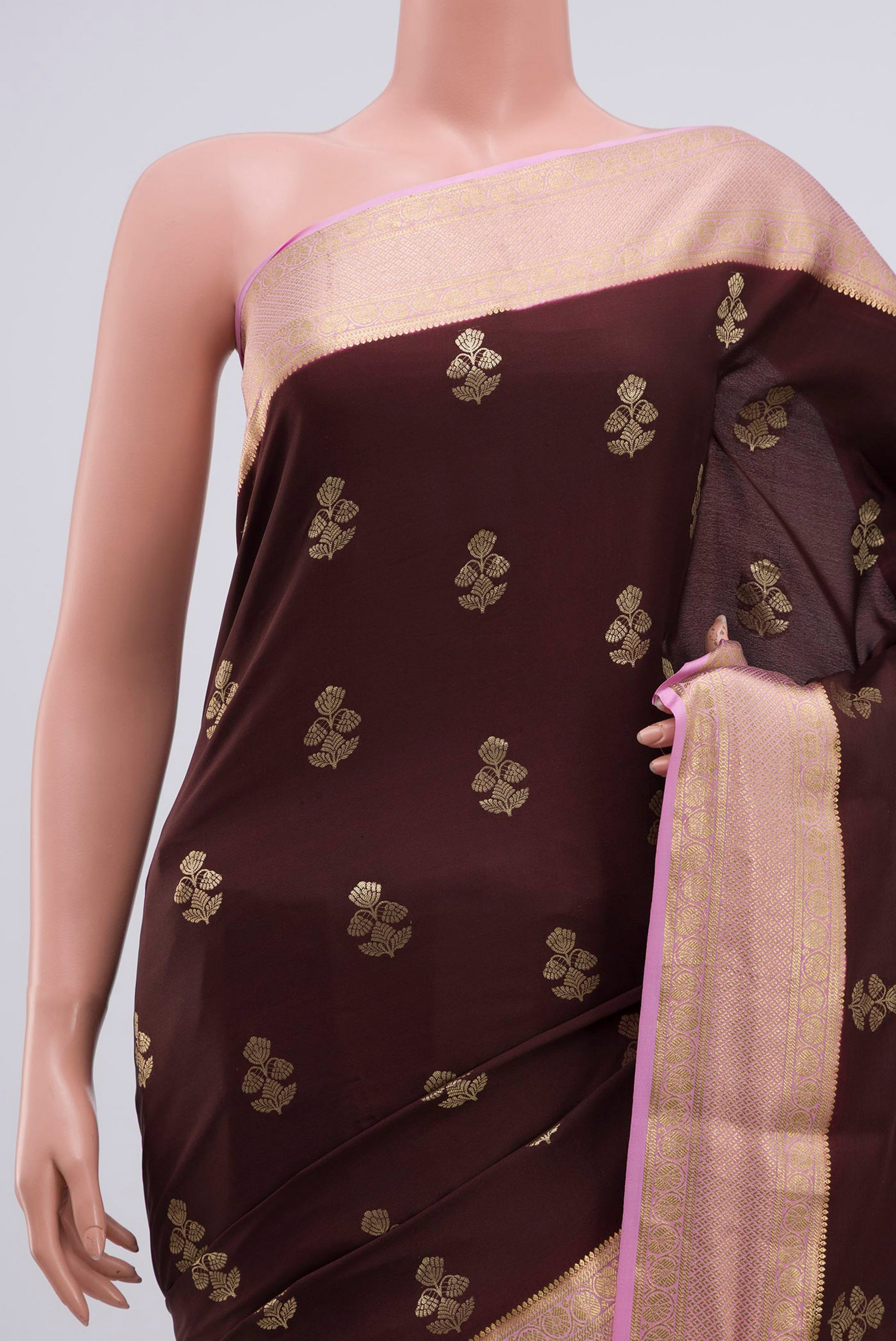Border image of Brown Crepe Saree with Zari Butta on the body and Zari Border. 