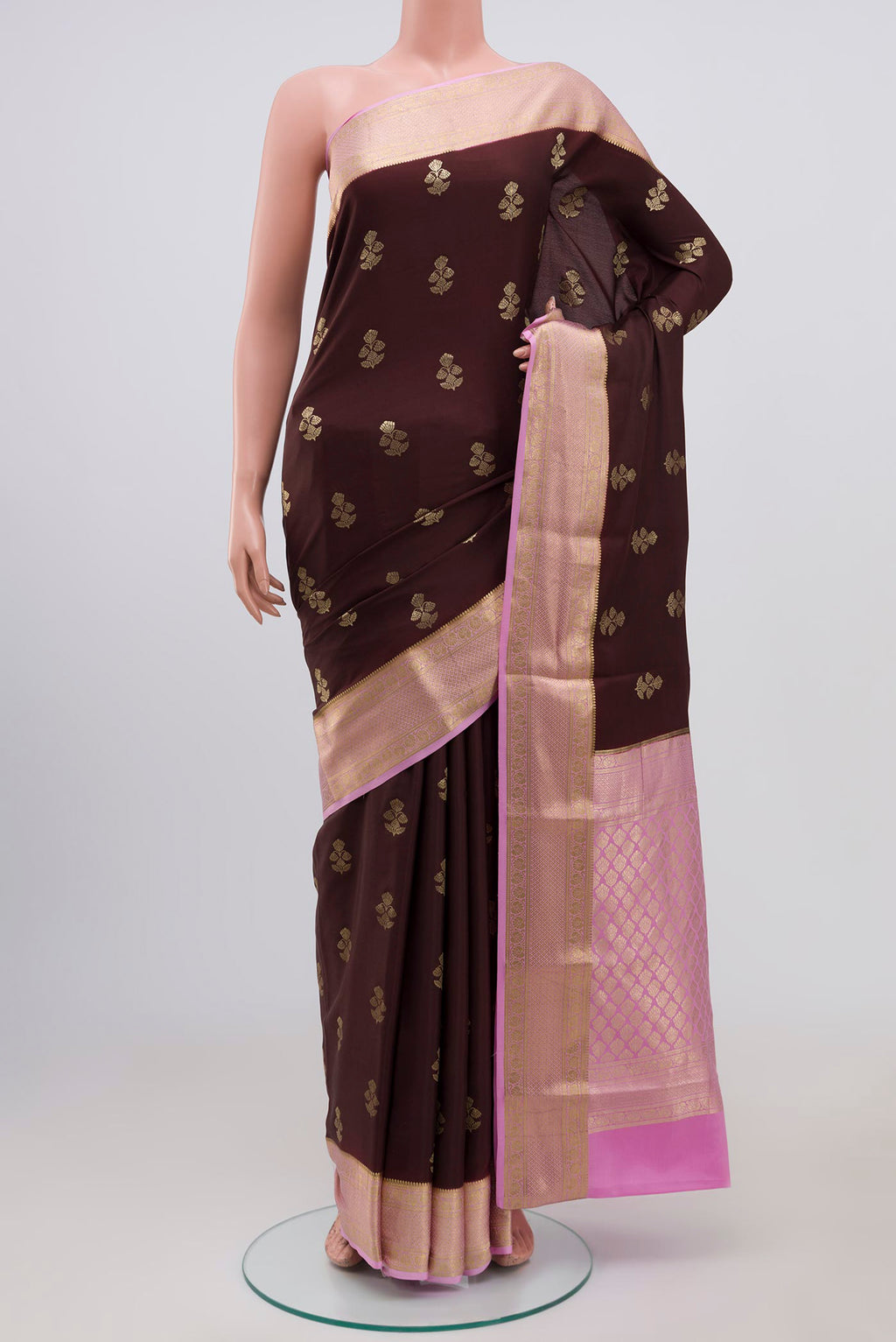 Brown Crepe Saree with Zari Butta on the body and Zari Border.  displayed on a mannequin