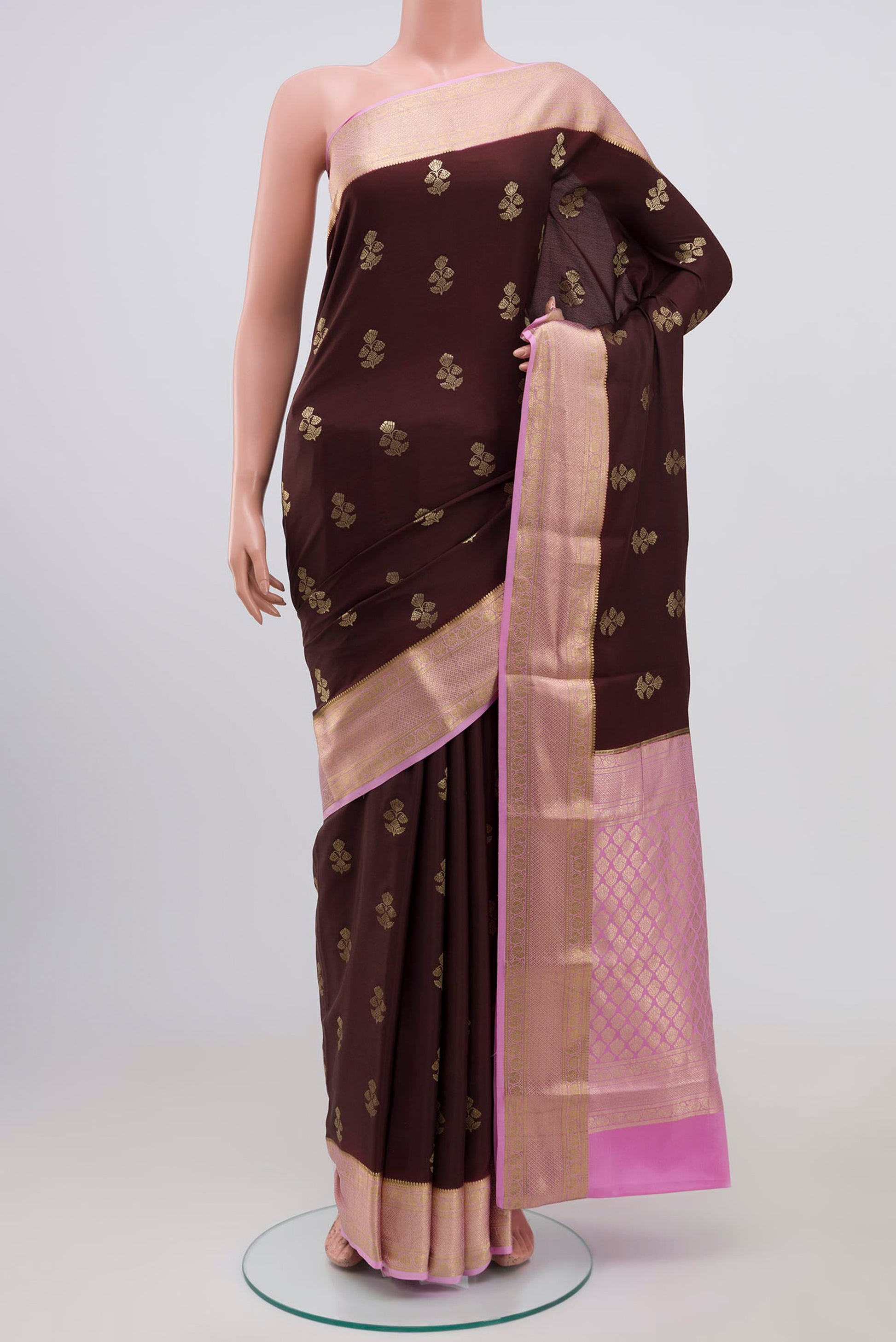 Brown Crepe Saree with Zari Butta on the body and Zari Border.  displayed on a mannequin