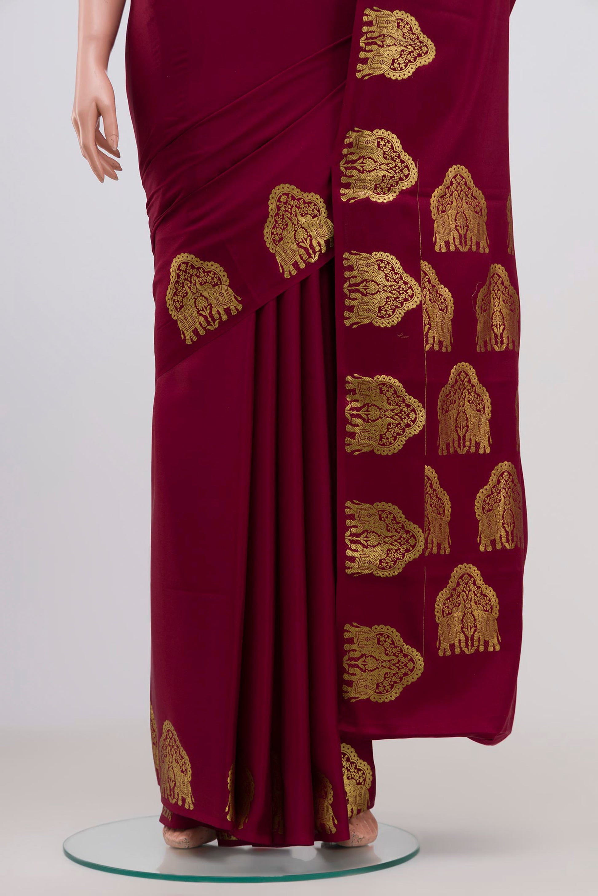 Pleats and pallu of Maroon Mysore Crepe Saree with Plain Body and Fancy Border. 