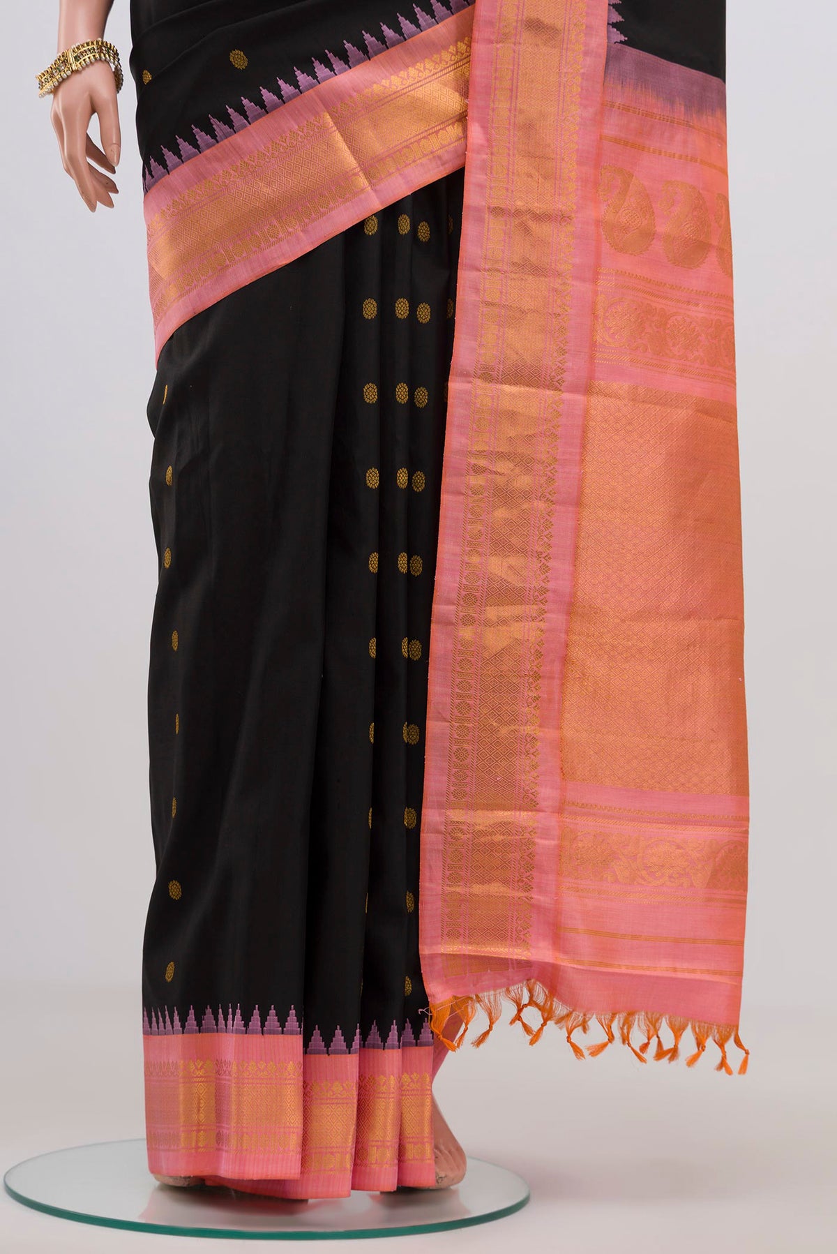Pleats and pallu of Black Gadwal Silk Saree with Zari Butta on the body and Zari Border. 