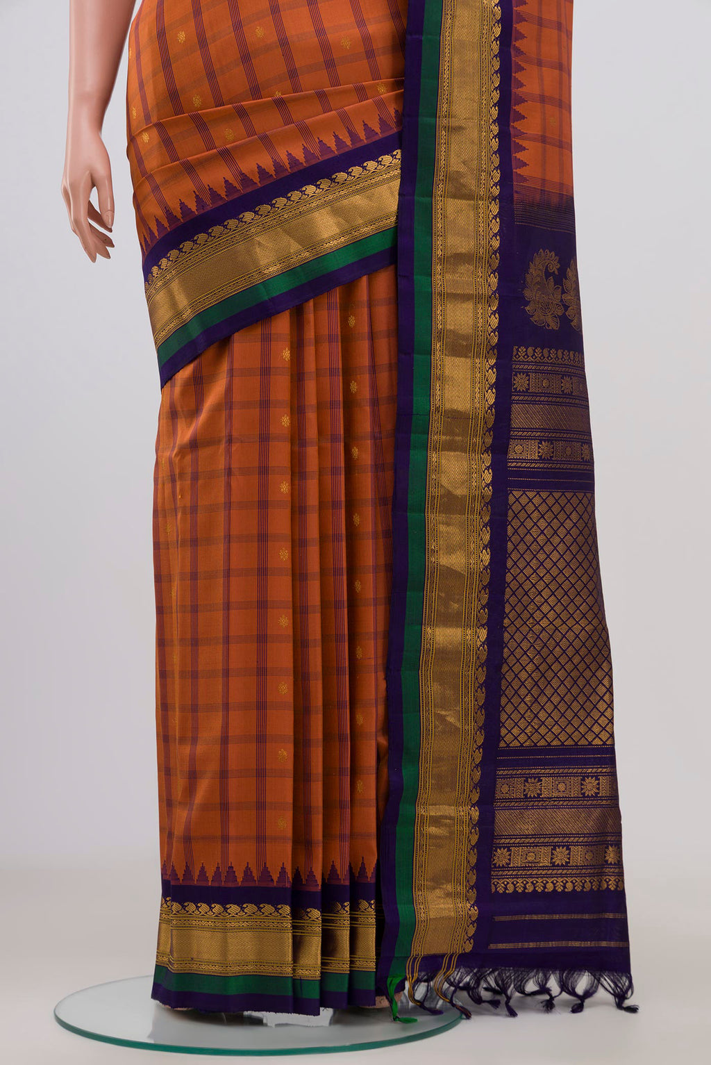 Pleats and pallu of Rust Gadwal Silk Saree with Zari Butta on the body and Zari Border. 
