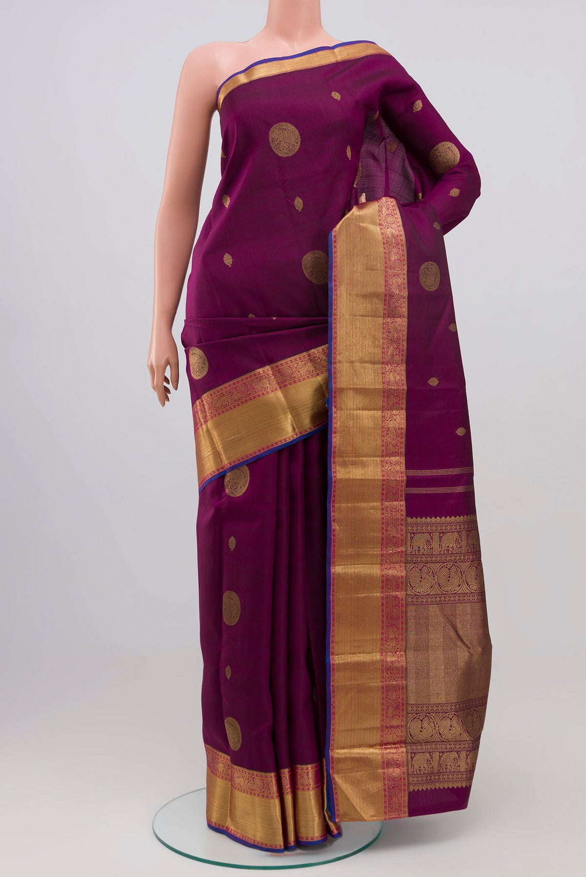 Pure Silk Pure Zari Purple Kanchipuram Saree with Zari Butta on the body and Zari Border.  displayed on a mannequin