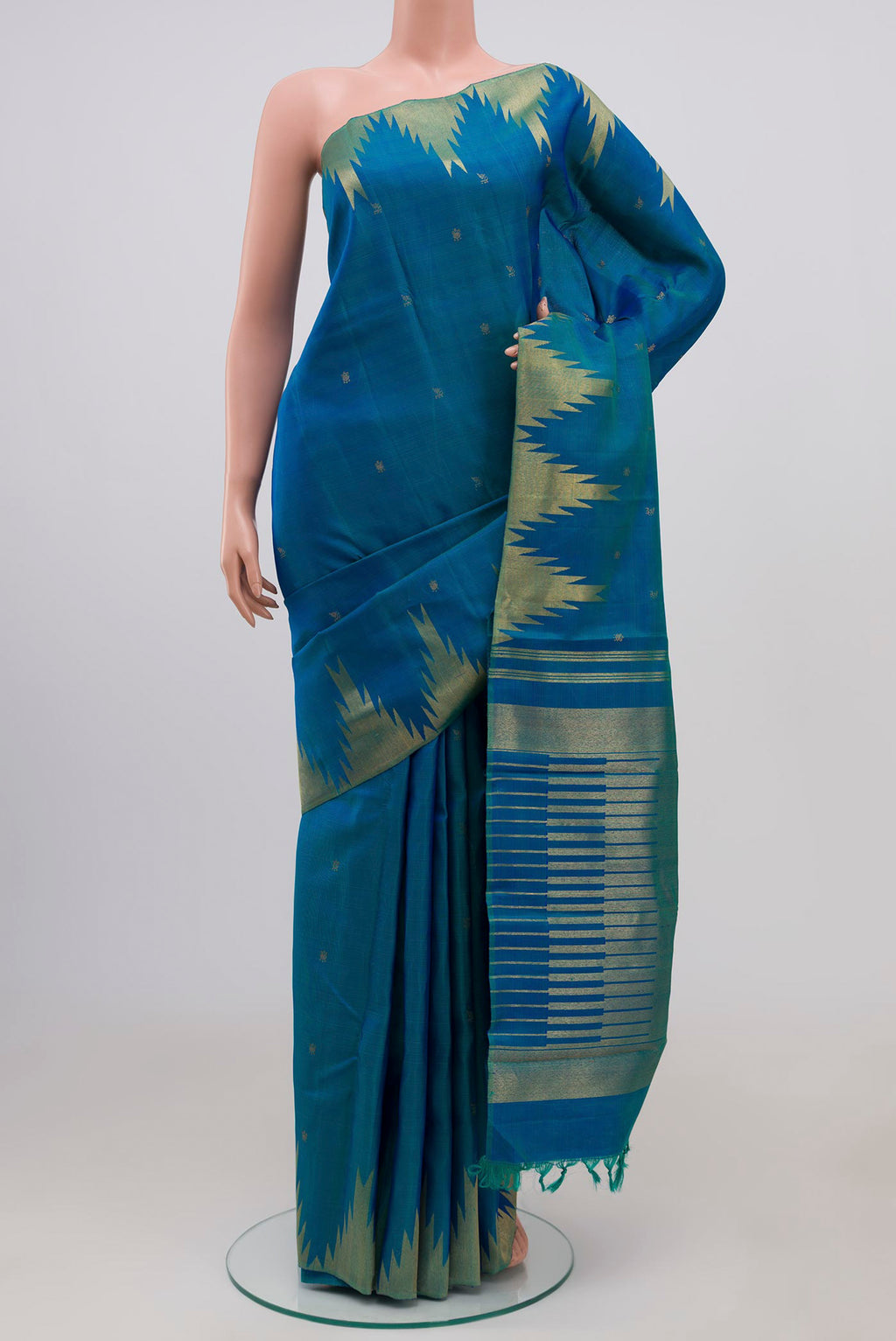 Pure Silk Pure Zari Peacock Blue Kanchipuram Saree with Zari Butta on the body and Temple Border.  displayed on a mannequin