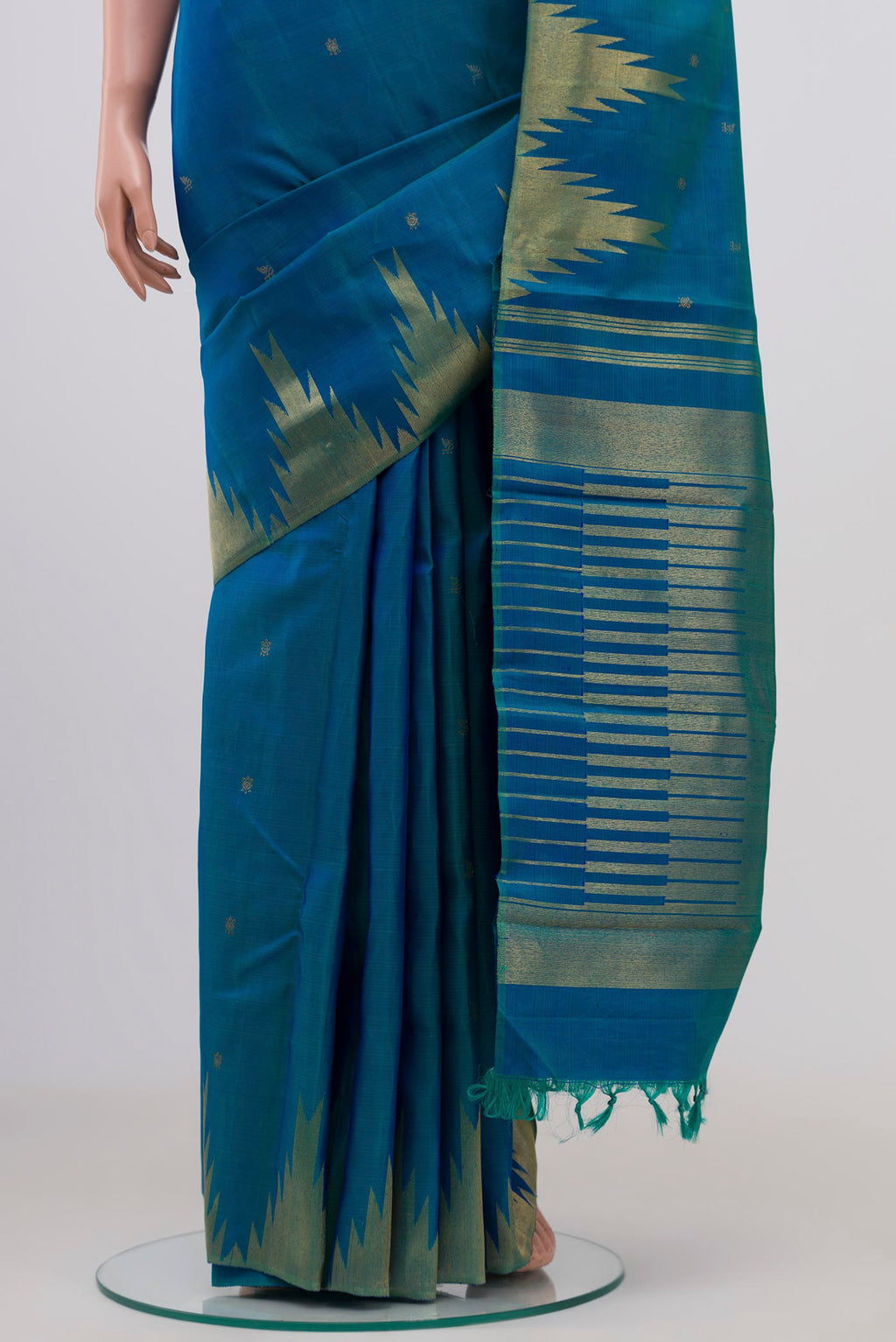 Pleats and pallu of Pure Silk Pure Zari Peacock Blue Kanchipuram Saree with Zari Butta on the body and Temple Border. 