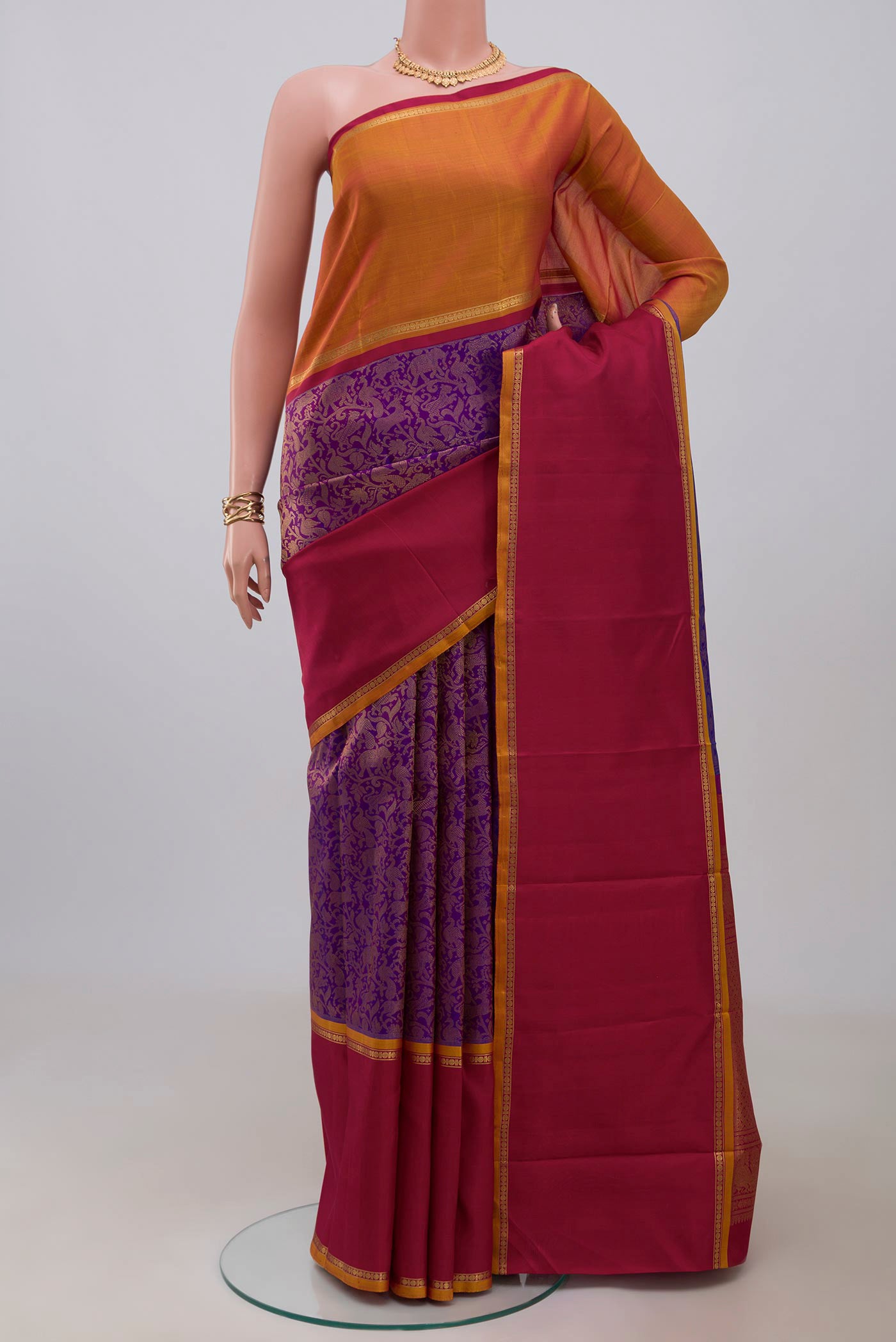 Pure Silk Pure Zari Purple Kanjivaram Saree with Zari Brocade on the body and Ganga Jamuna Border.  displayed on a mannequin