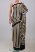 Cream Blended Satin Silk Saree with Ajrakh Print on the body and Printed Border.  displayed on a mannequin
