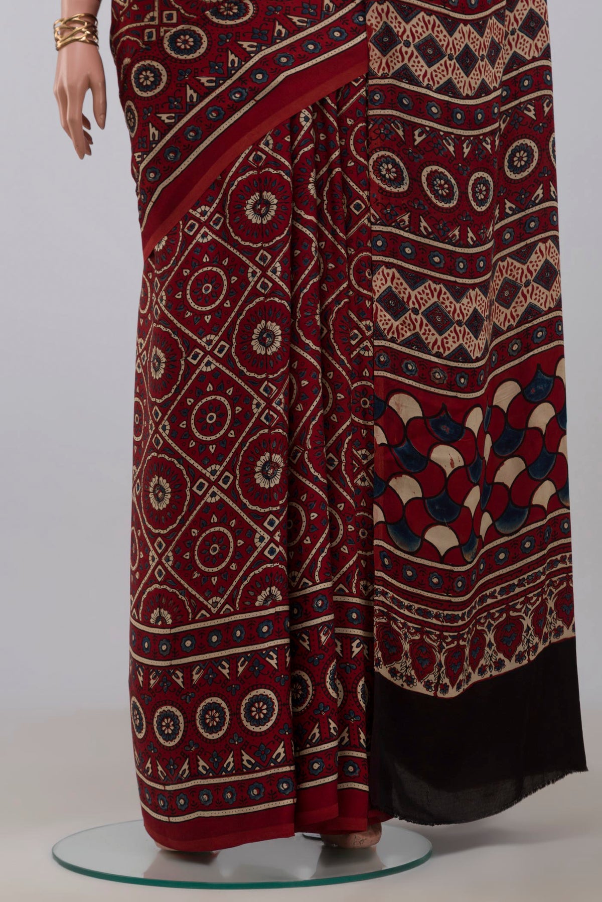 Pleats and pallu of Maroon Blended Satin Silk Saree with Ajrakh Print on the body and Printed Border. 