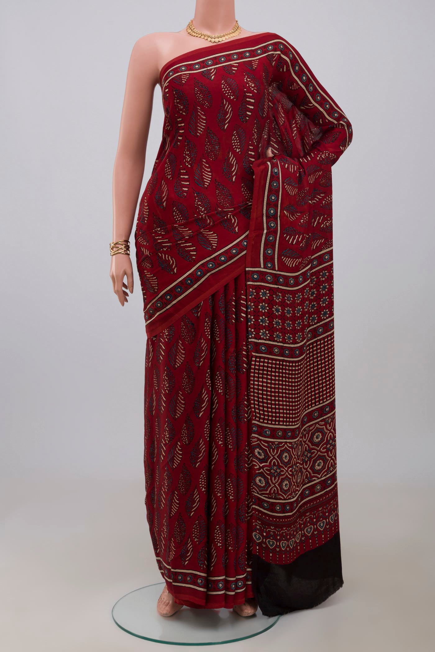 Maroon Blended Satin Silk Saree with Ajrakh Print on the body and Printed Border.  displayed on a mannequin
