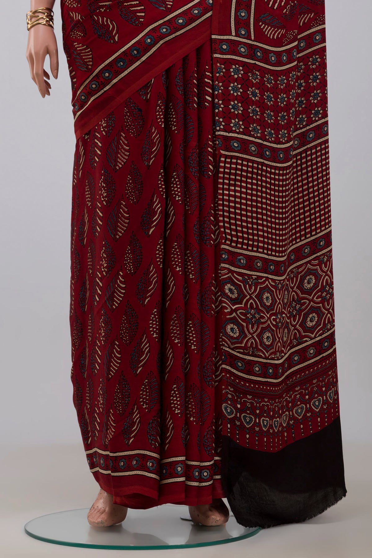 Pleats and pallu of Maroon Blended Satin Silk Saree with Ajrakh Print on the body and Printed Border. 