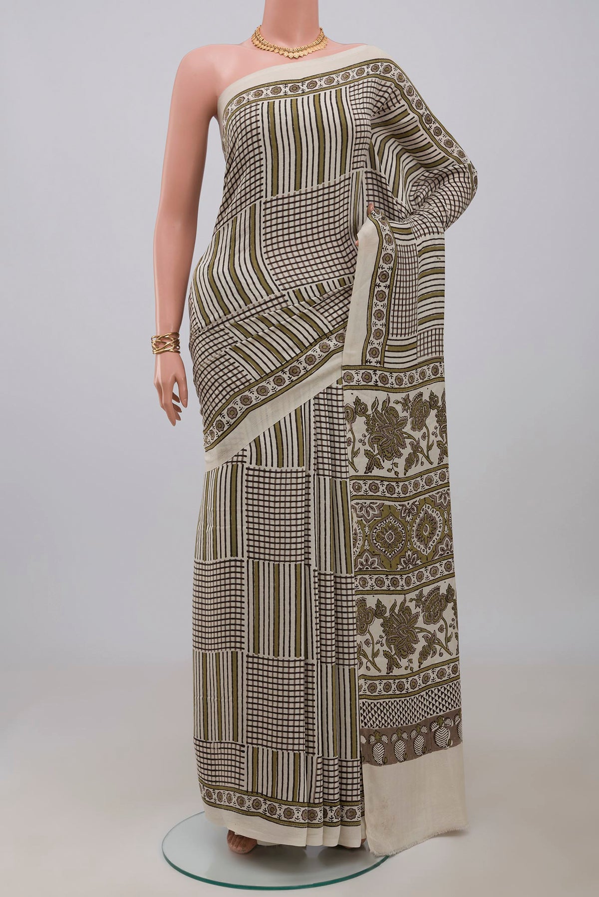 Cream Blended Satin Silk Saree with Ajrakh Print on the body and Printed Border.  displayed on a mannequin