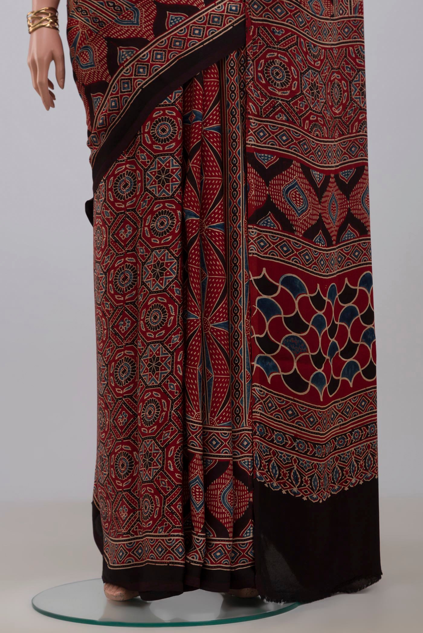Pleats and pallu of Maroon Blended Satin Silk Saree with Ajrakh Print on the body and Printed Border. 