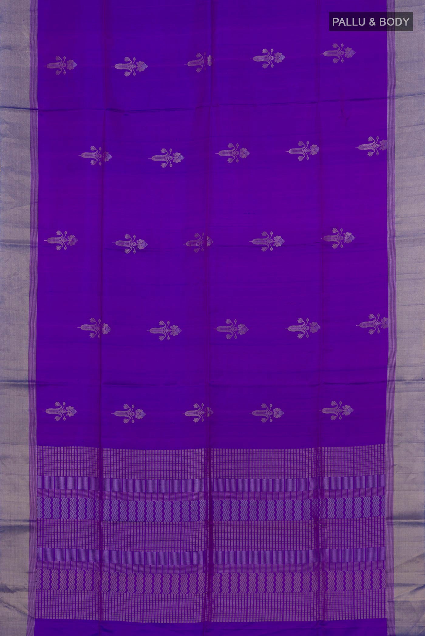 Flat view of Lavender Soft Silk Saree with Zari Butta on the body and Zari Border. 