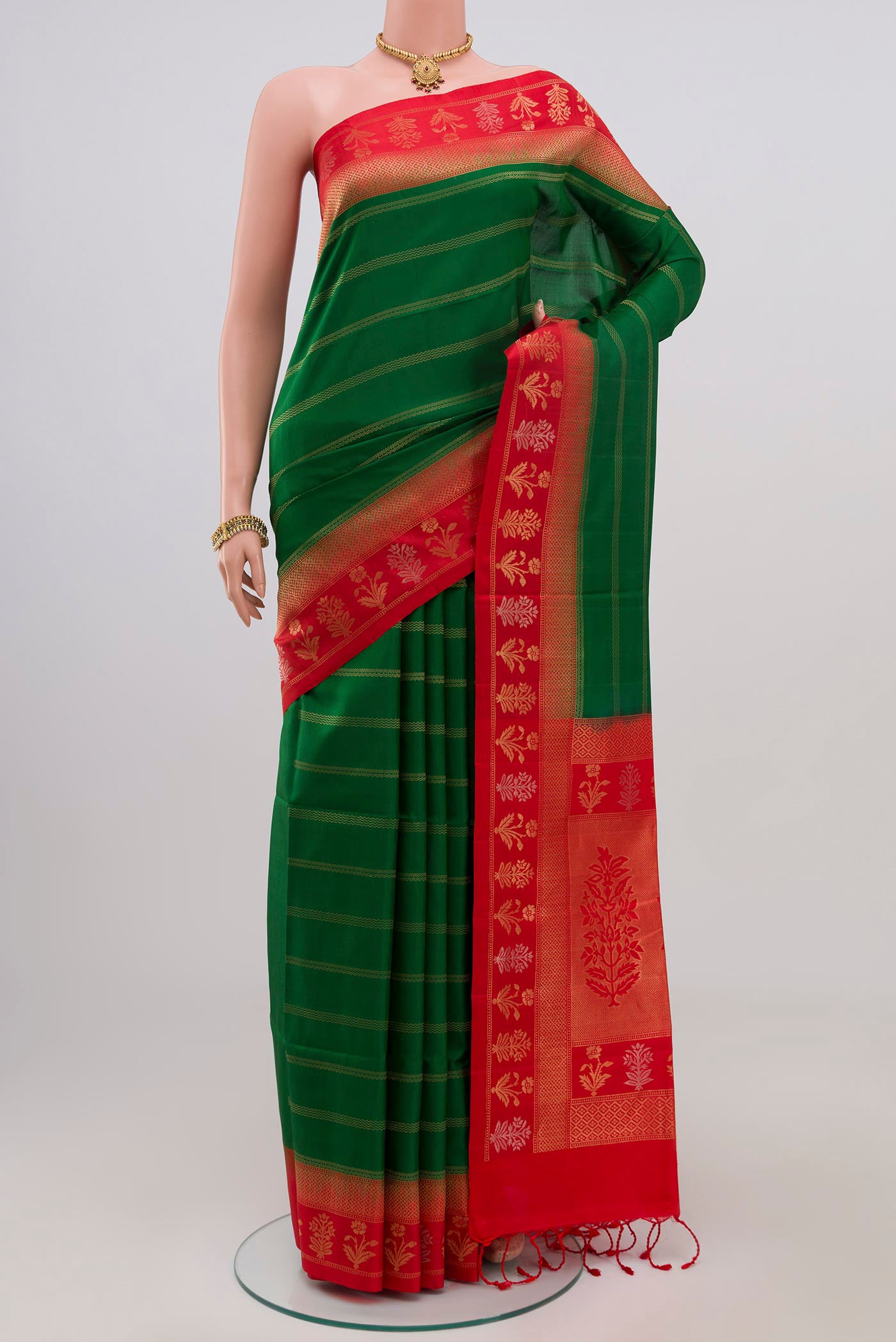 Green Soft Silk Saree with Stripes on the body and Fancy Border.  displayed on a mannequin