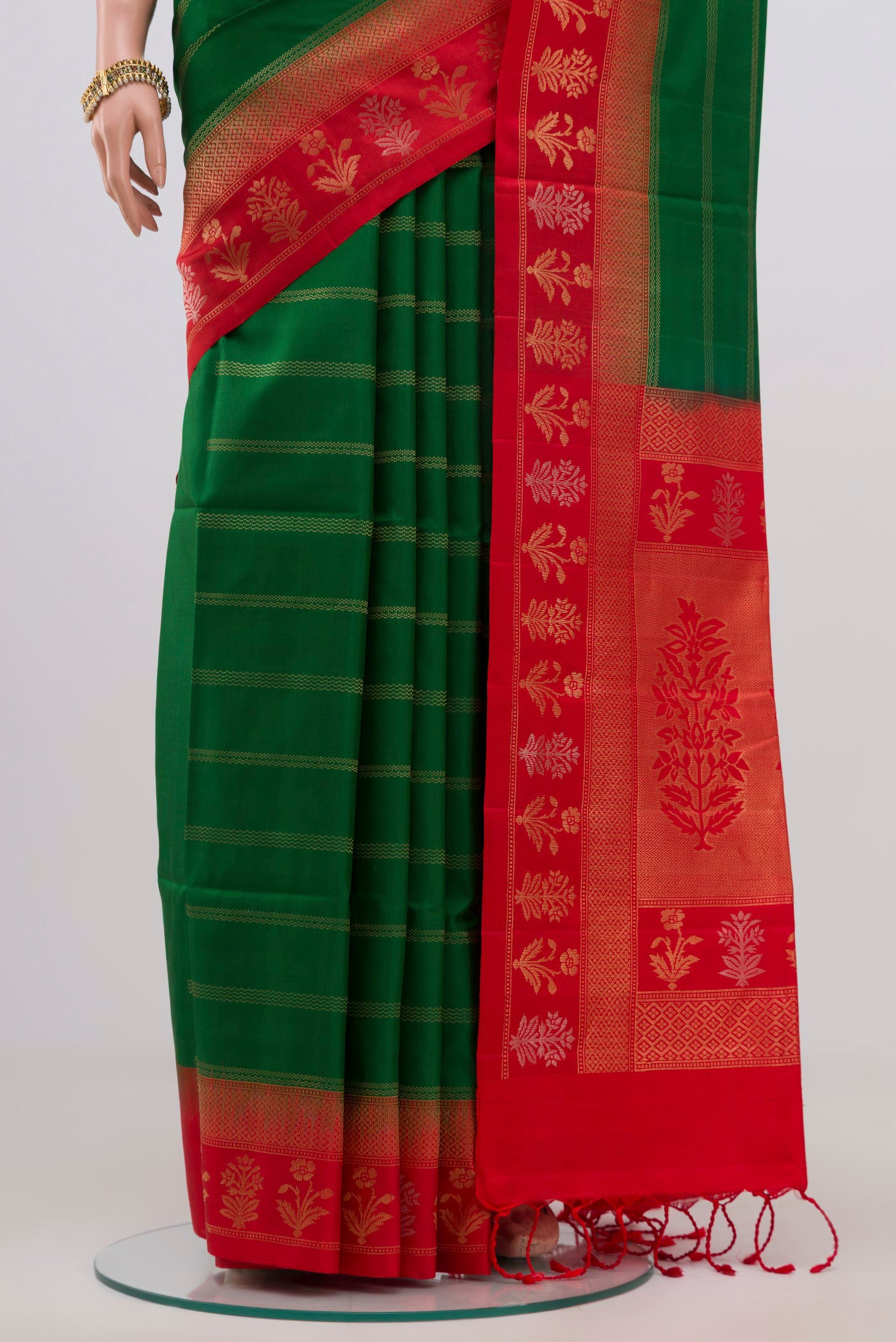 Pleats and pallu of Green Soft Silk Saree with Stripes on the body and Fancy Border. 