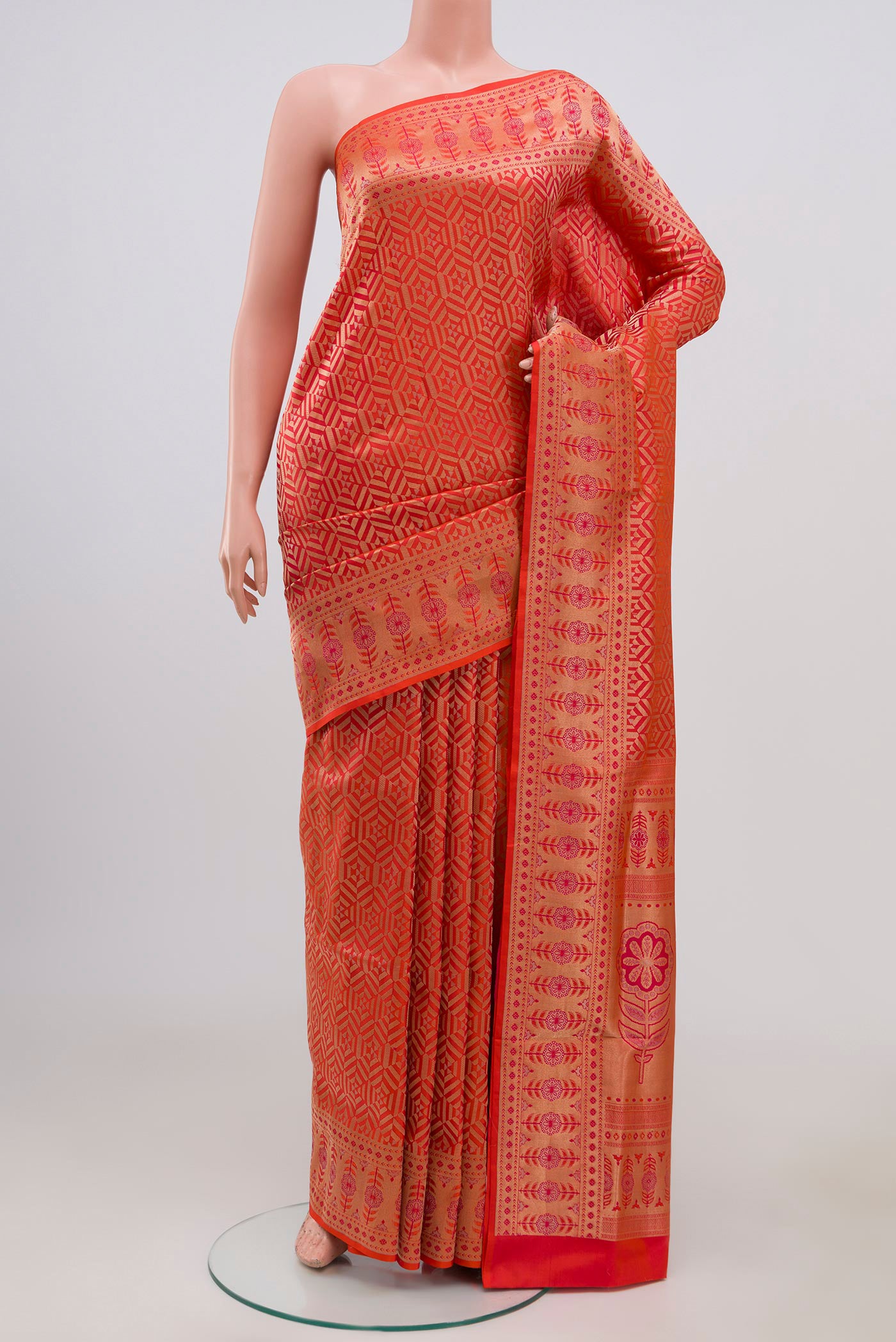 Orange Soft Silk Saree with Zari Brocade on the body and Fancy Border.  displayed on a mannequin