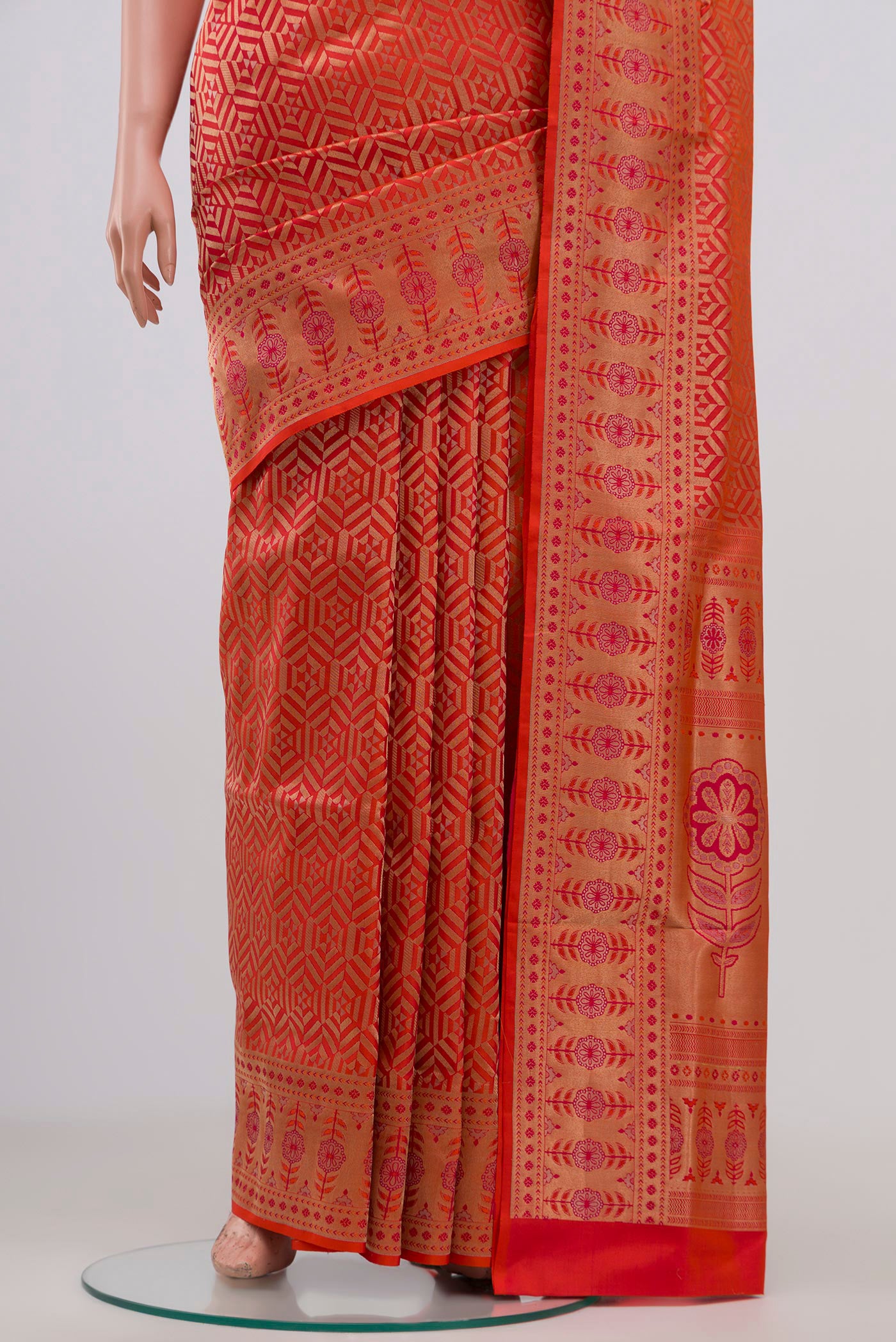Pleats and pallu of Orange Soft Silk Saree with Zari Brocade on the body and Fancy Border. 