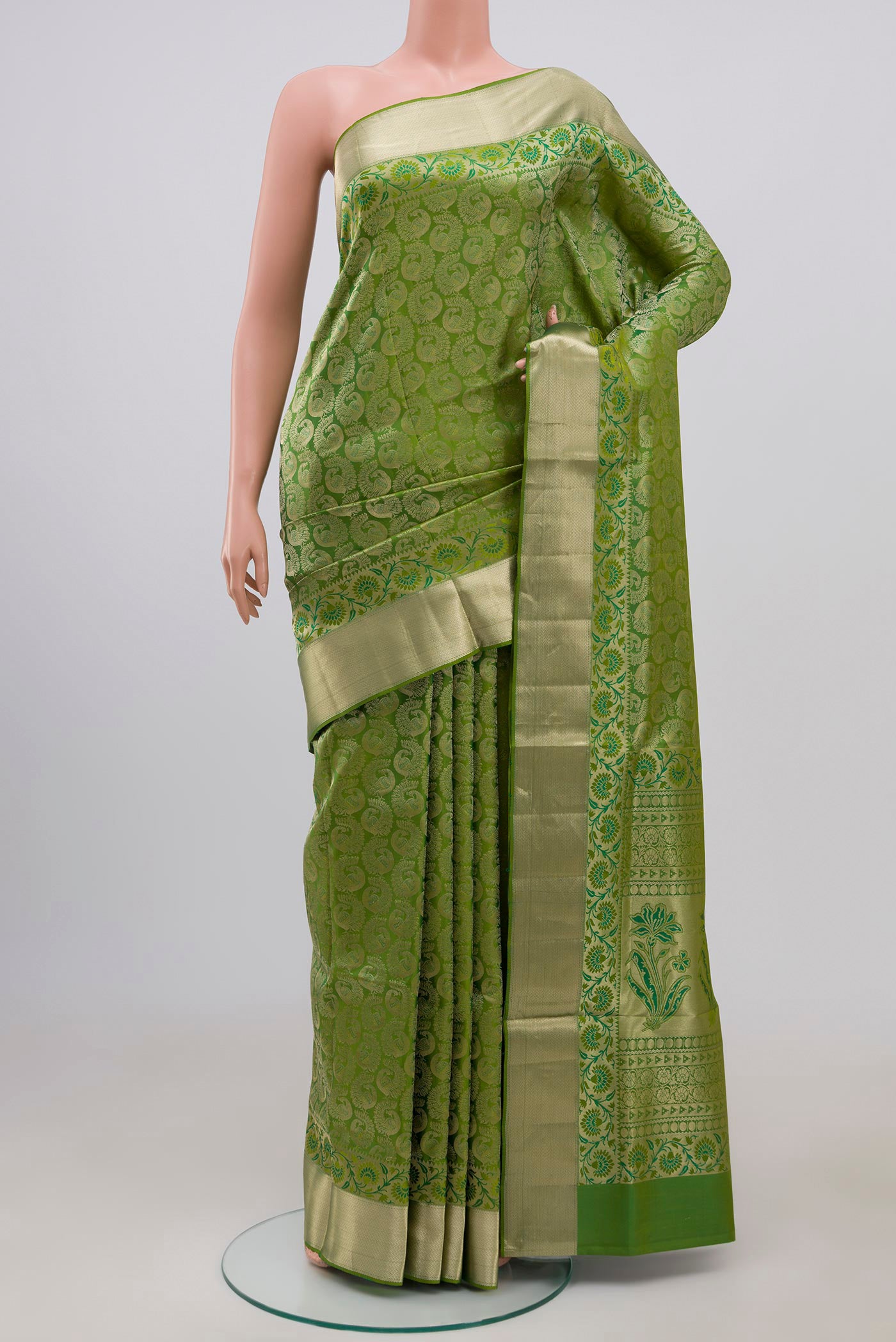 Green Soft Silk Saree with Zari Brocade on the body and Zari Border.  displayed on a mannequin
