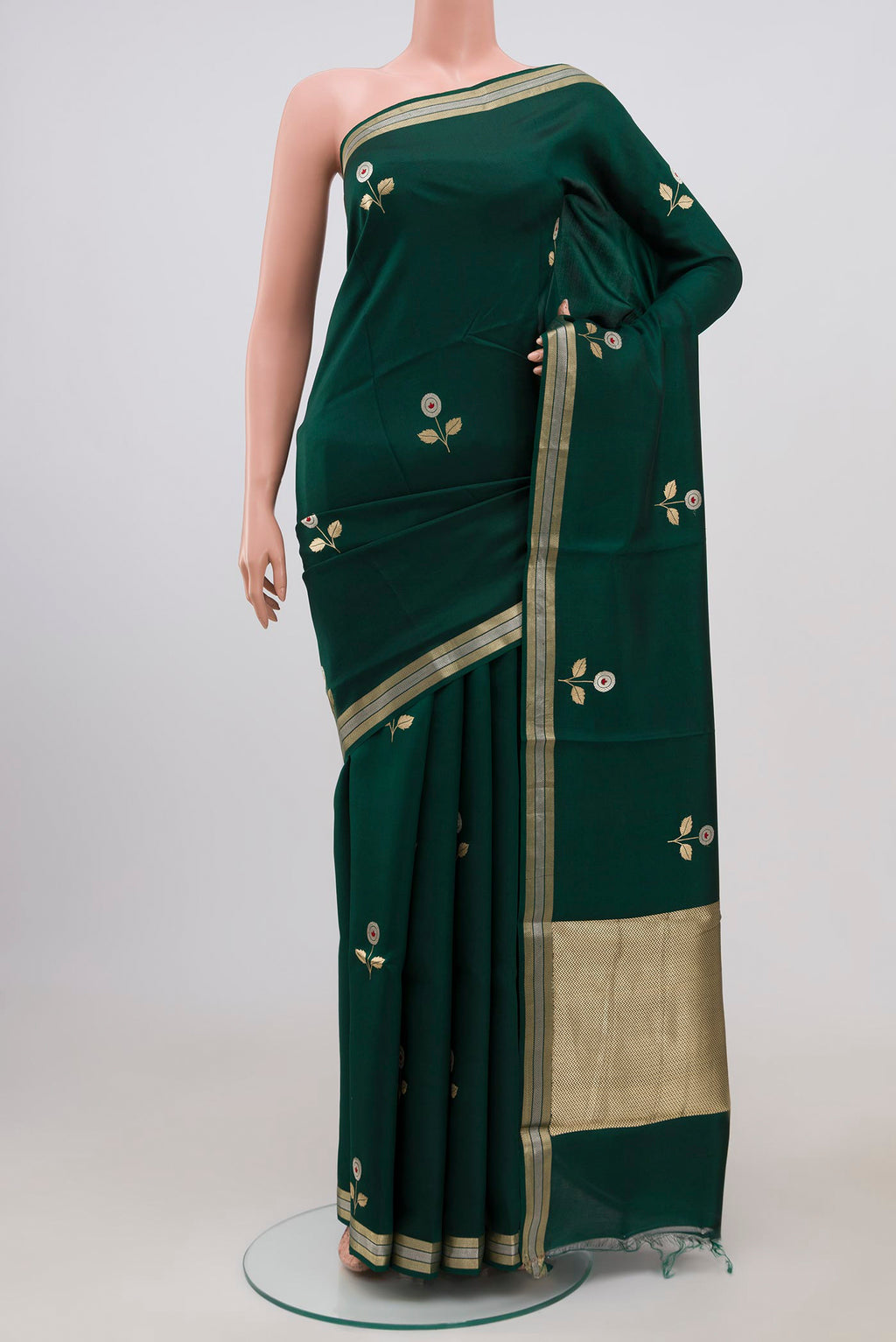 Bottle Green Banarasi Katan Silk Saree with Zari Butta on the body and Zari Border.  displayed on a mannequin
