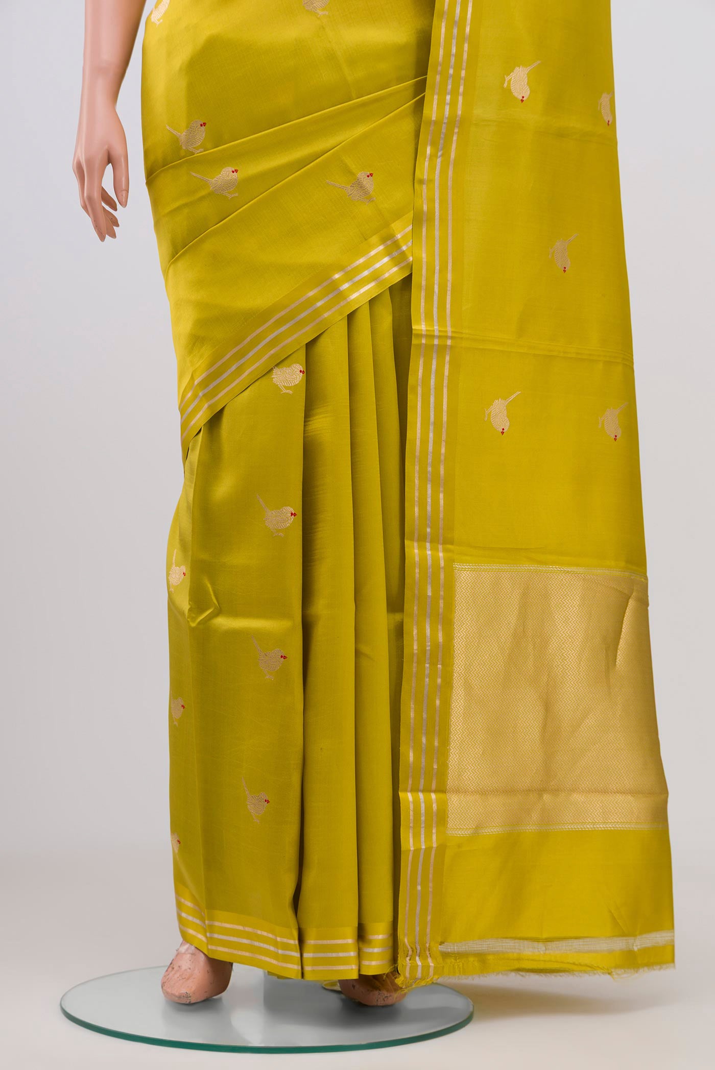 Pleats and pallu of Lemon Yellow Raw Silk Saree with Zari Butta on the body and Thin Zari Line. 
