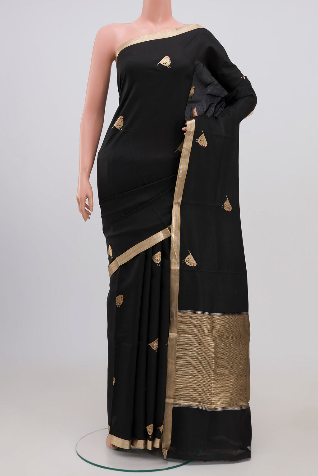 Black Raw Silk Saree with Zari Butta on the body and Zari Border.  displayed on a mannequin