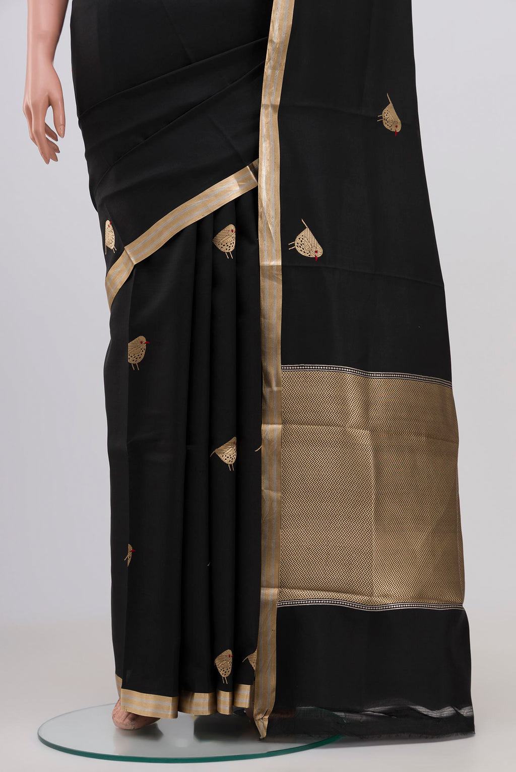 Pleats and pallu of Black Raw Silk Saree with Zari Butta on the body and Zari Border. 
