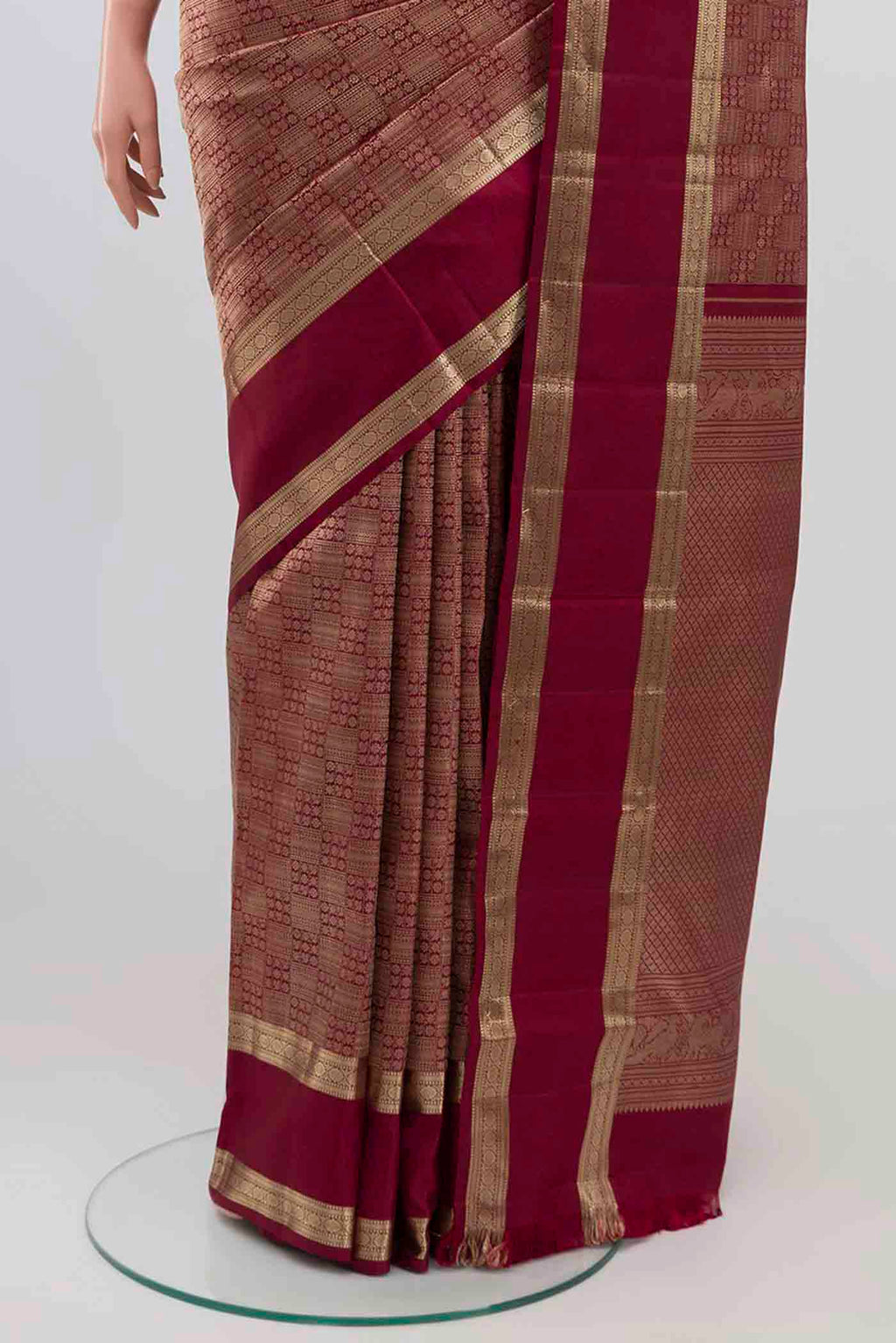 Pleats and pallu of Maroon Kanchipuram Silk Saree with Zari Brocade on the body and Zari Border. 