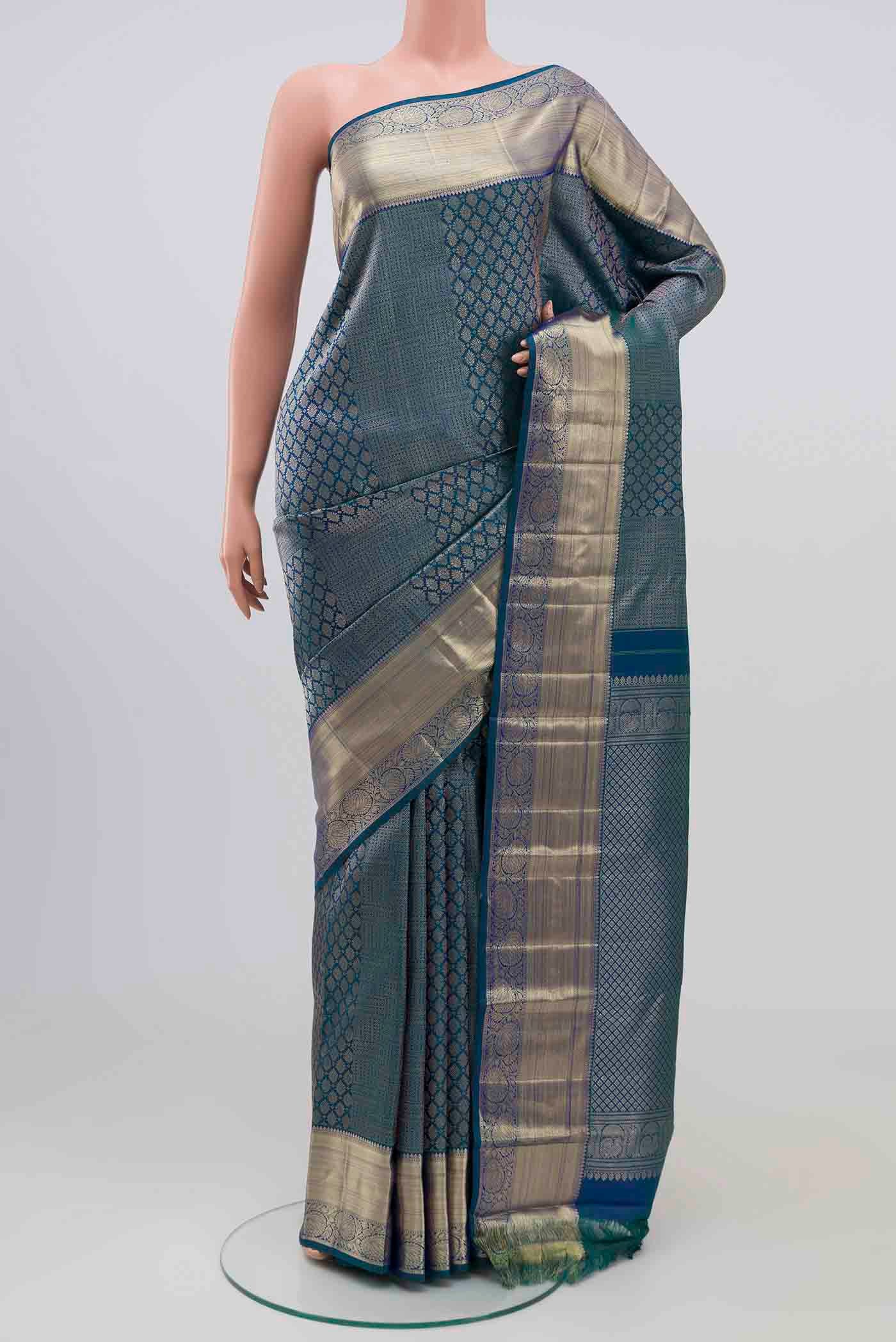 Green With Blue Color Kanchipuram Silk Saree with Zari Brocade on the body and Zari Border.  displayed on a mannequin