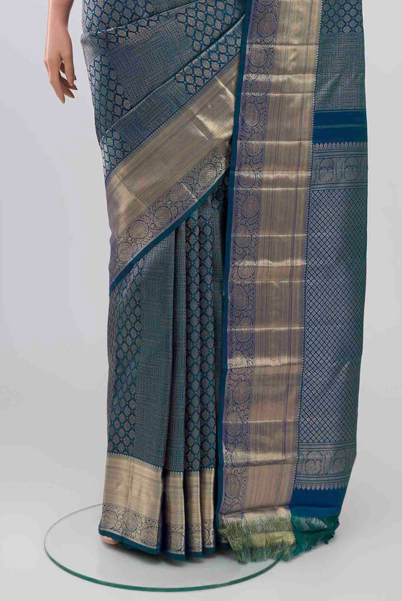 Pleats and pallu of Green With Blue Color Kanchipuram Silk Saree with Zari Brocade on the body and Zari Border. 
