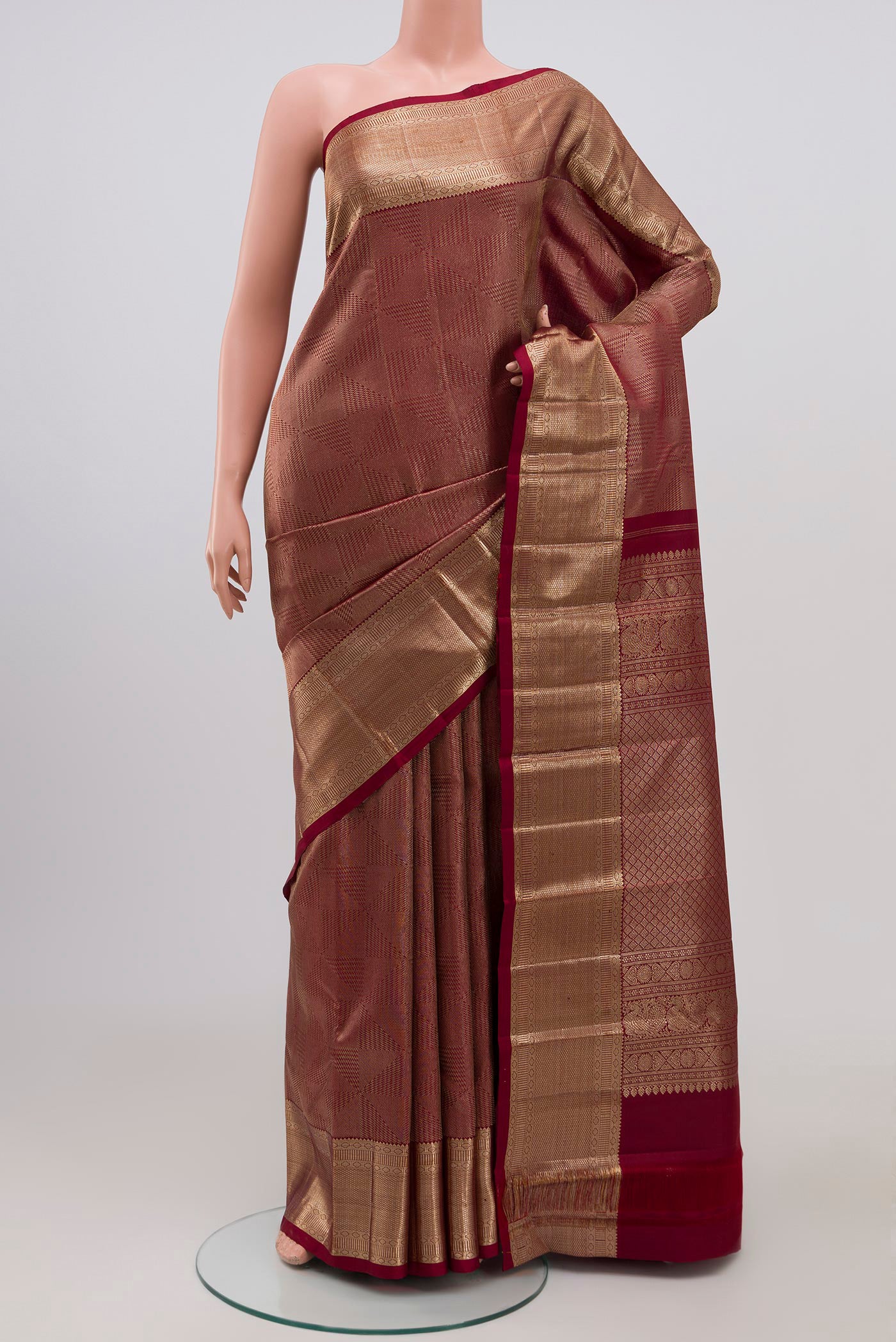Maroon Kanchipuram Silk Saree with Zari Brocade on the body and Zari Border.  displayed on a mannequin